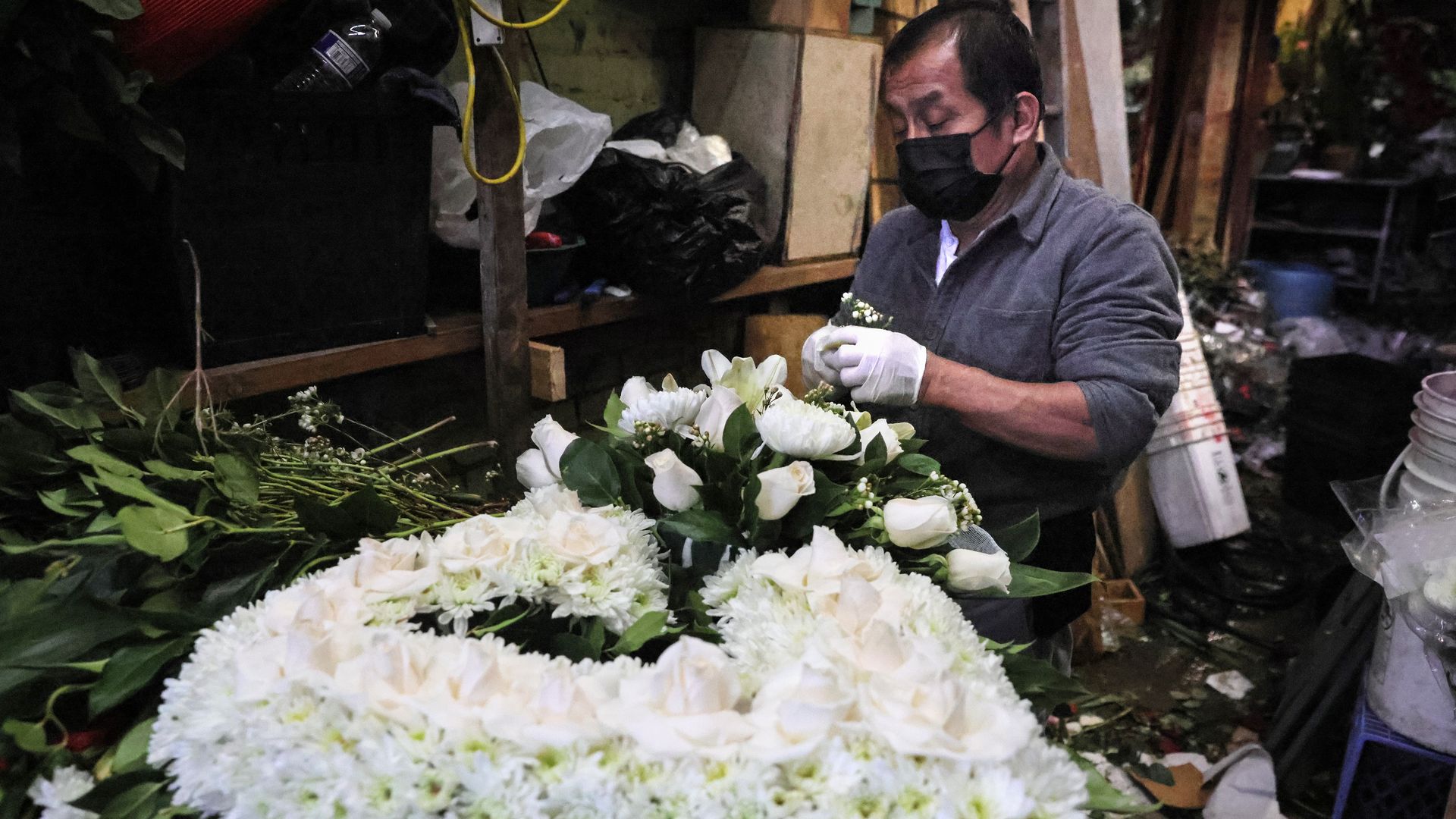 A man prepares a funeral arrangement in in Los Angeles, California, Feb. 12.