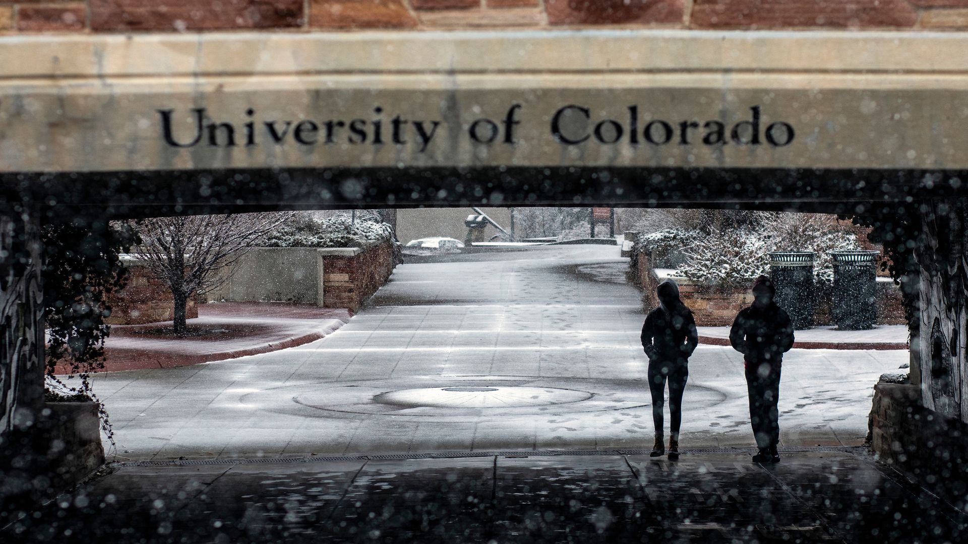 Students walk under a bridge at University of Colorado