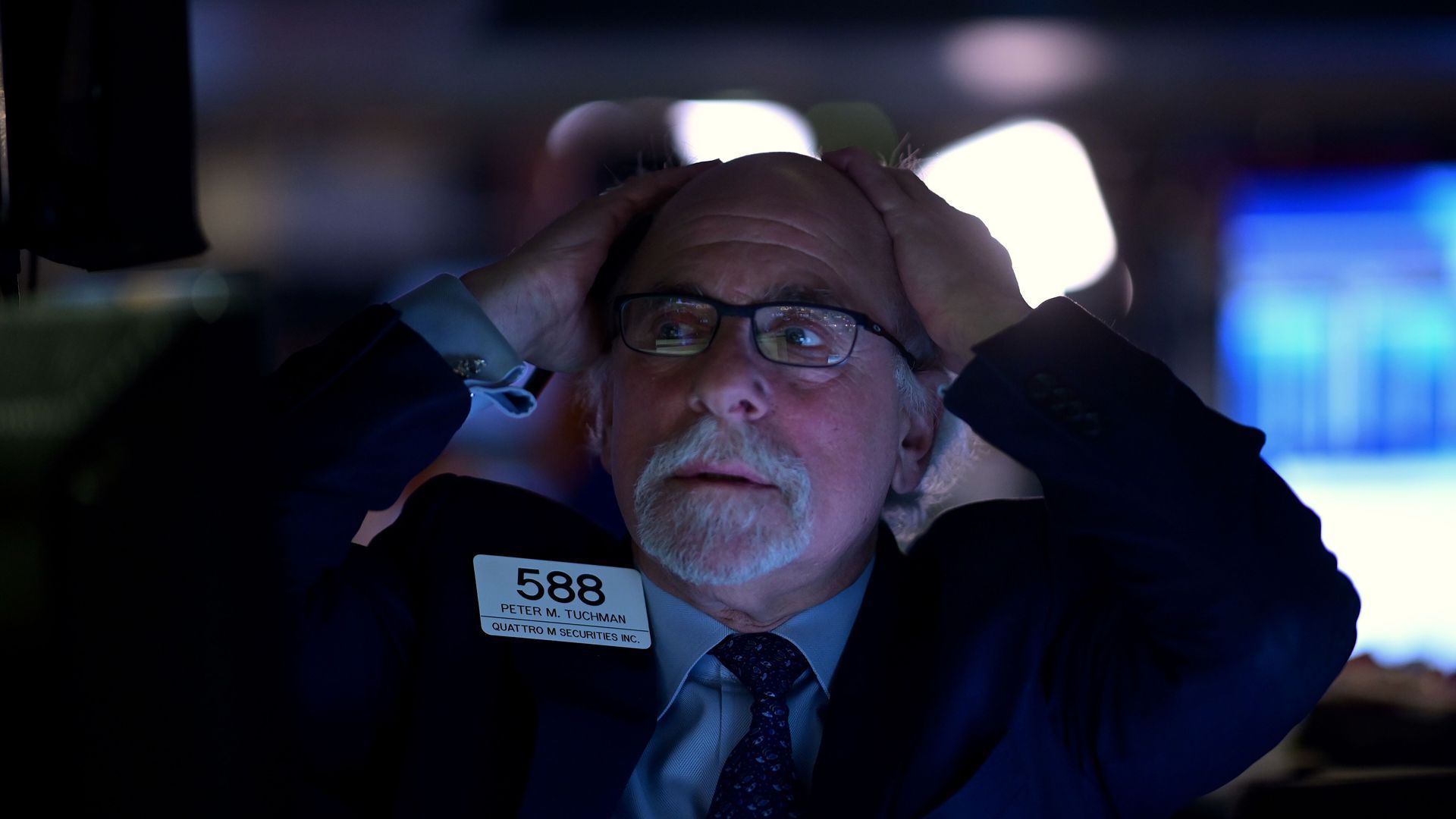 Trader grips his head on the trading floor