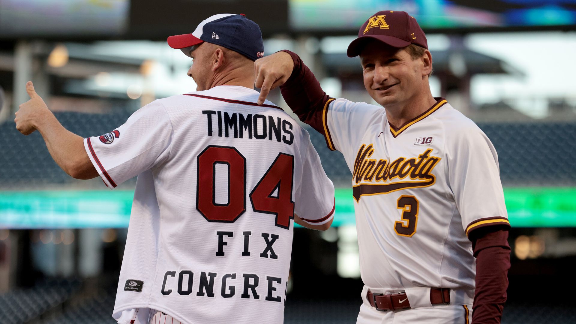 Two lawmakers are seen laughing during the annual congressional baseball game.