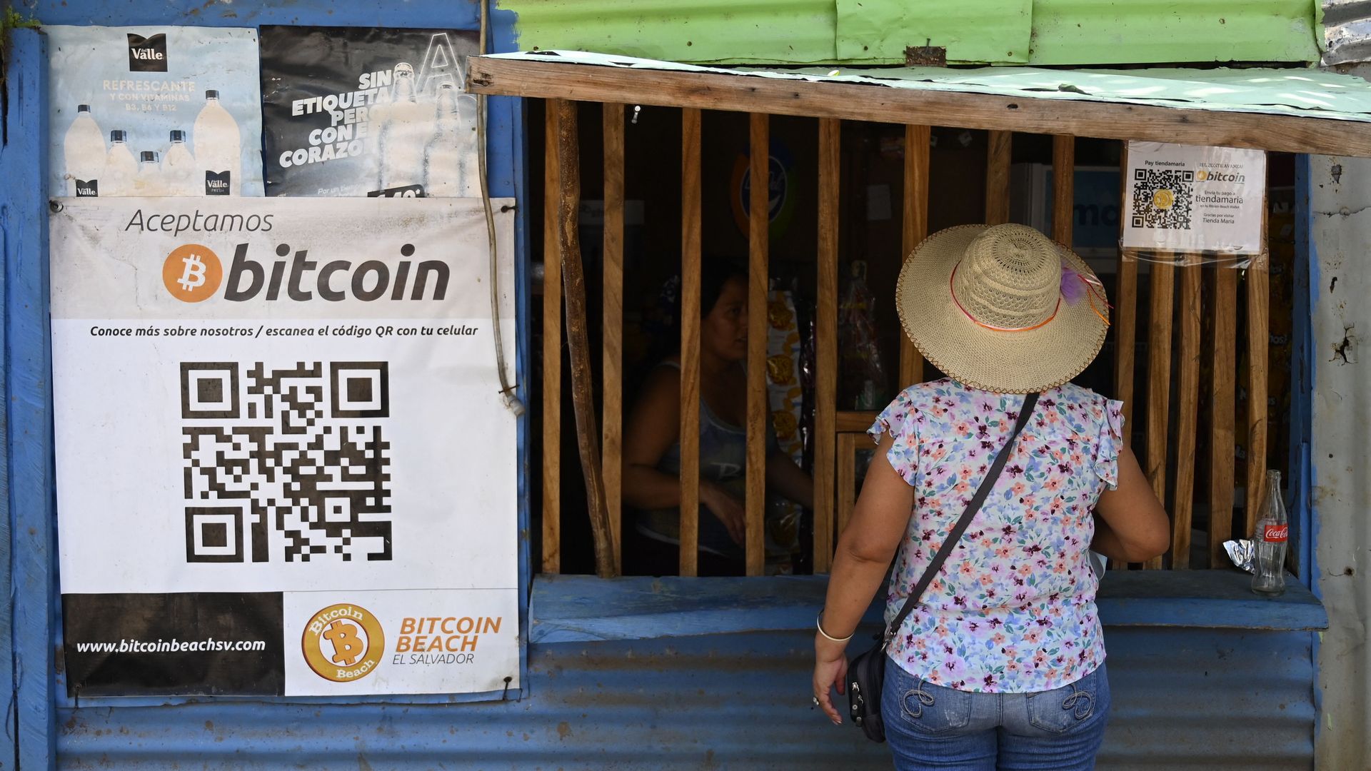 A woman buys in a store that accepts bitcoins in El Zonte