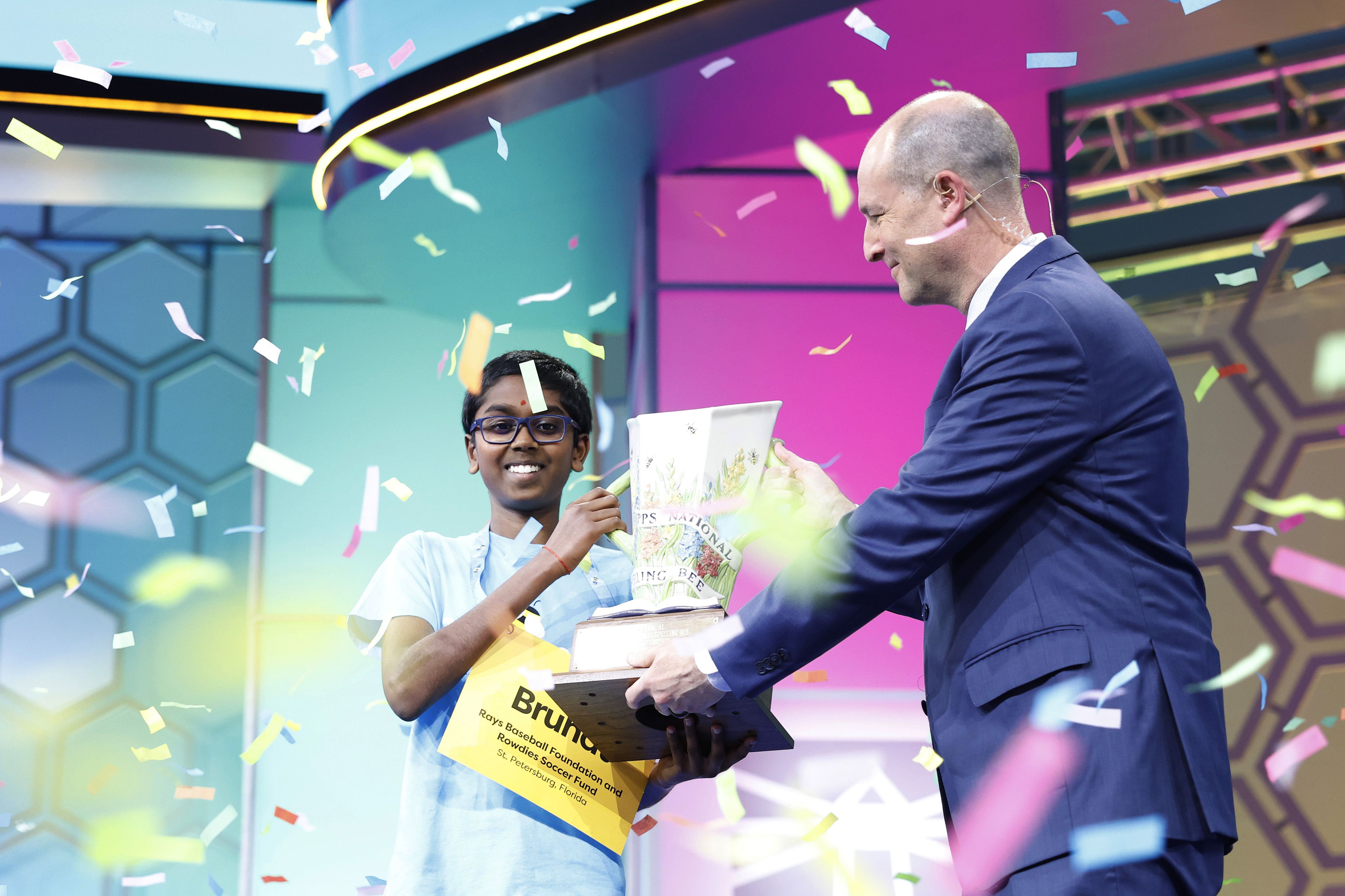 Tampa's Bruhat Soma accepts the trophy for winning this year's Scripps National Spelling Bee.