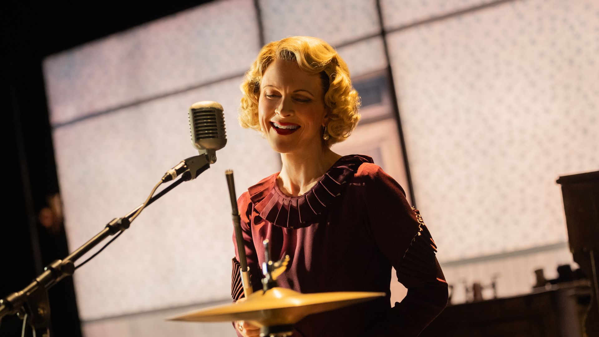 Blonde woman singing at a mic