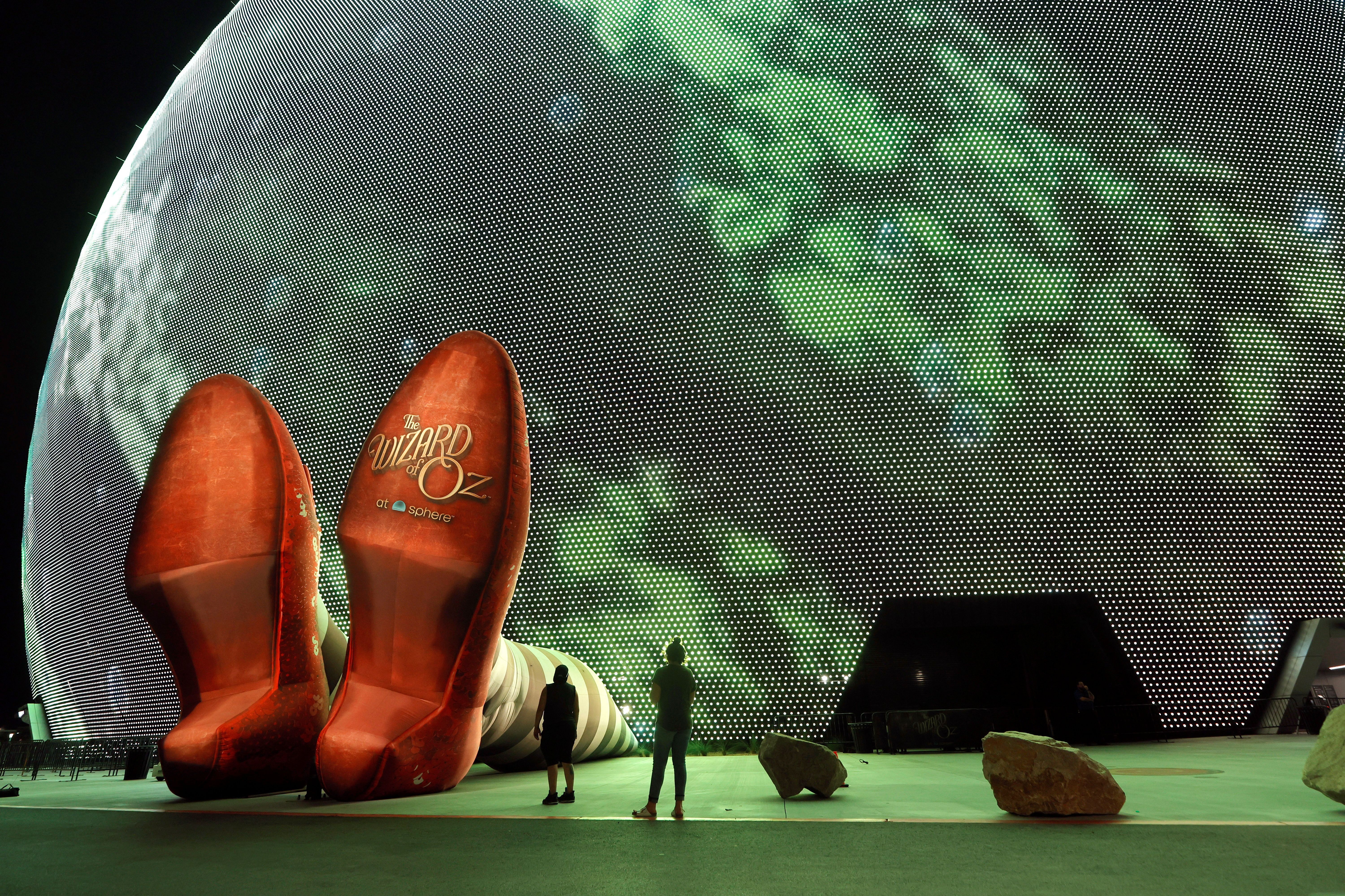 A pair of 50-feet-long legs and 22-foot-tall ruby slippers protrude from The Sphere in Las Vegas to promote the"Wizard of Oz at Sphere" movie. Photo: Steve Marcus/Reuters