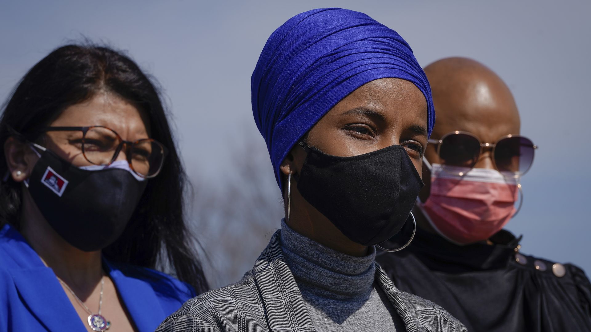 Photo of a masked Ilhan Omar and Ayanna Pressley