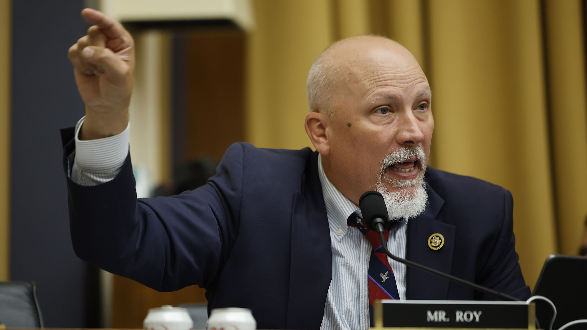 Rep. Chip Roy, wearing a blue suit and sitting at a committee dais.