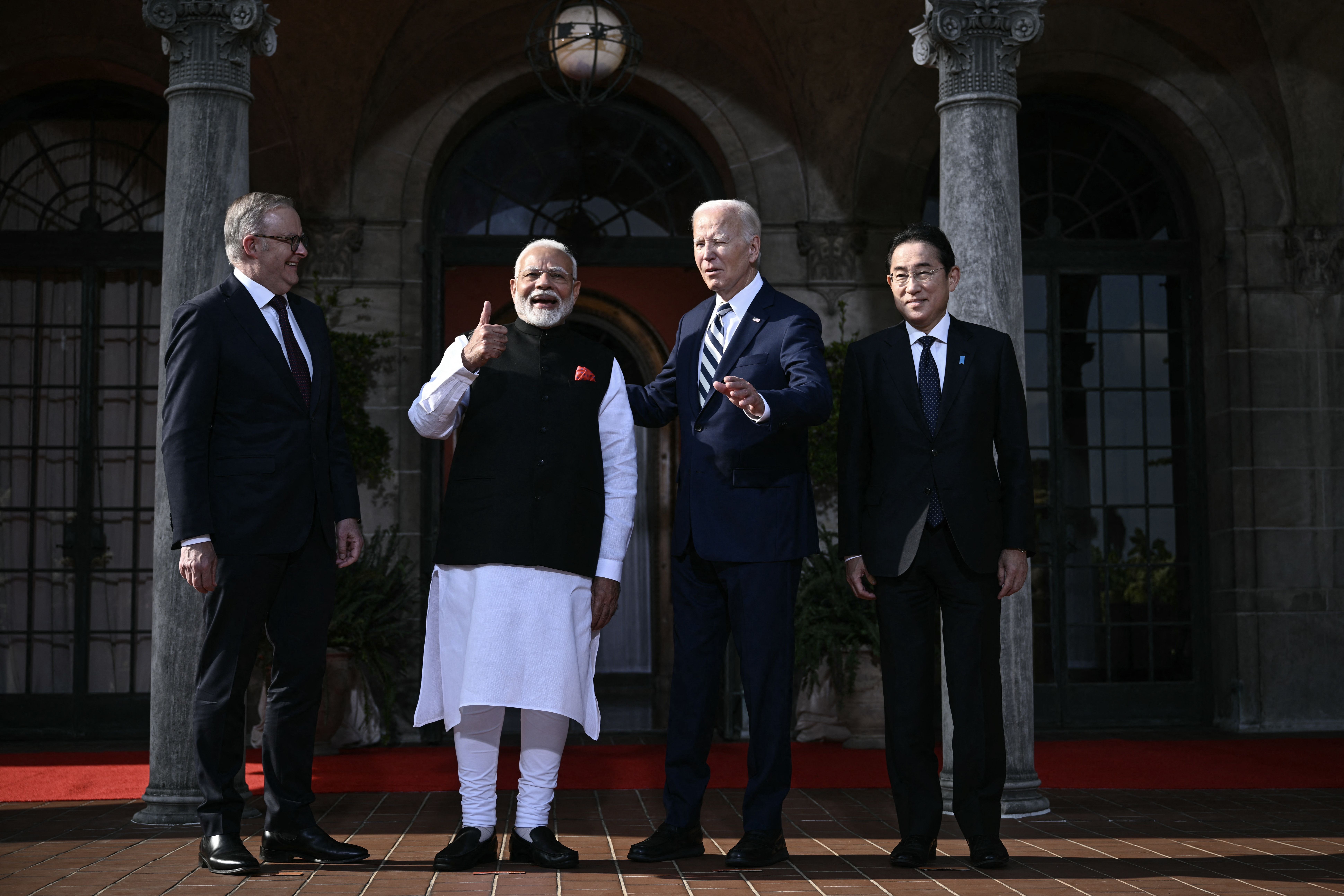 TOPSHOT - US President Joe Biden (3R) participates in a Quadrilateral Summit family photo with Australian Prime Minister Anthony Albanese (L), Indian Prime Minister Narendra Modi (2L), and Japanese Prime Minister Fumio Kishida (R) at the Archmere Academy in Wilmington, Delaware