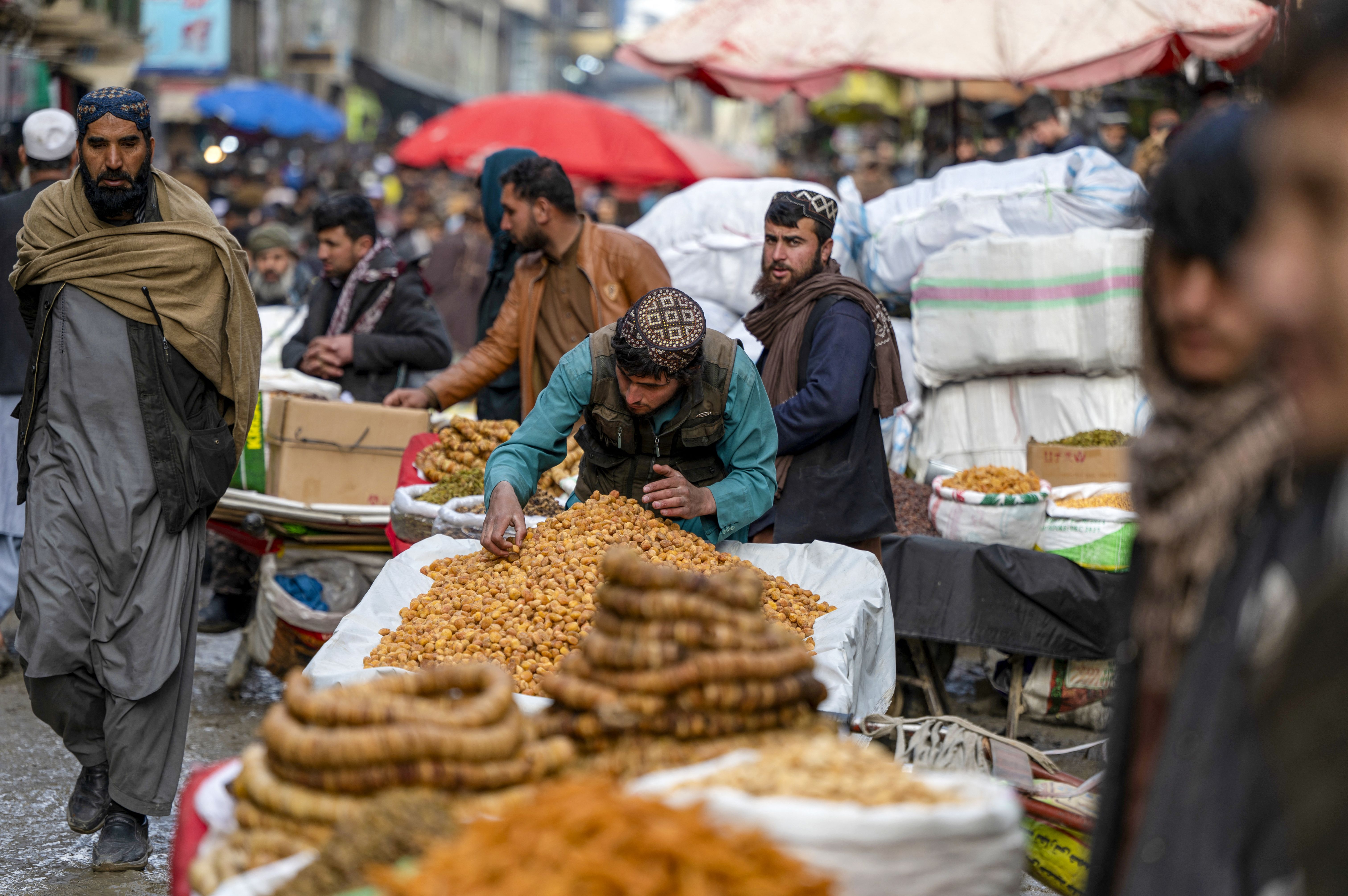 Afghans sell dry fruits at a market 
