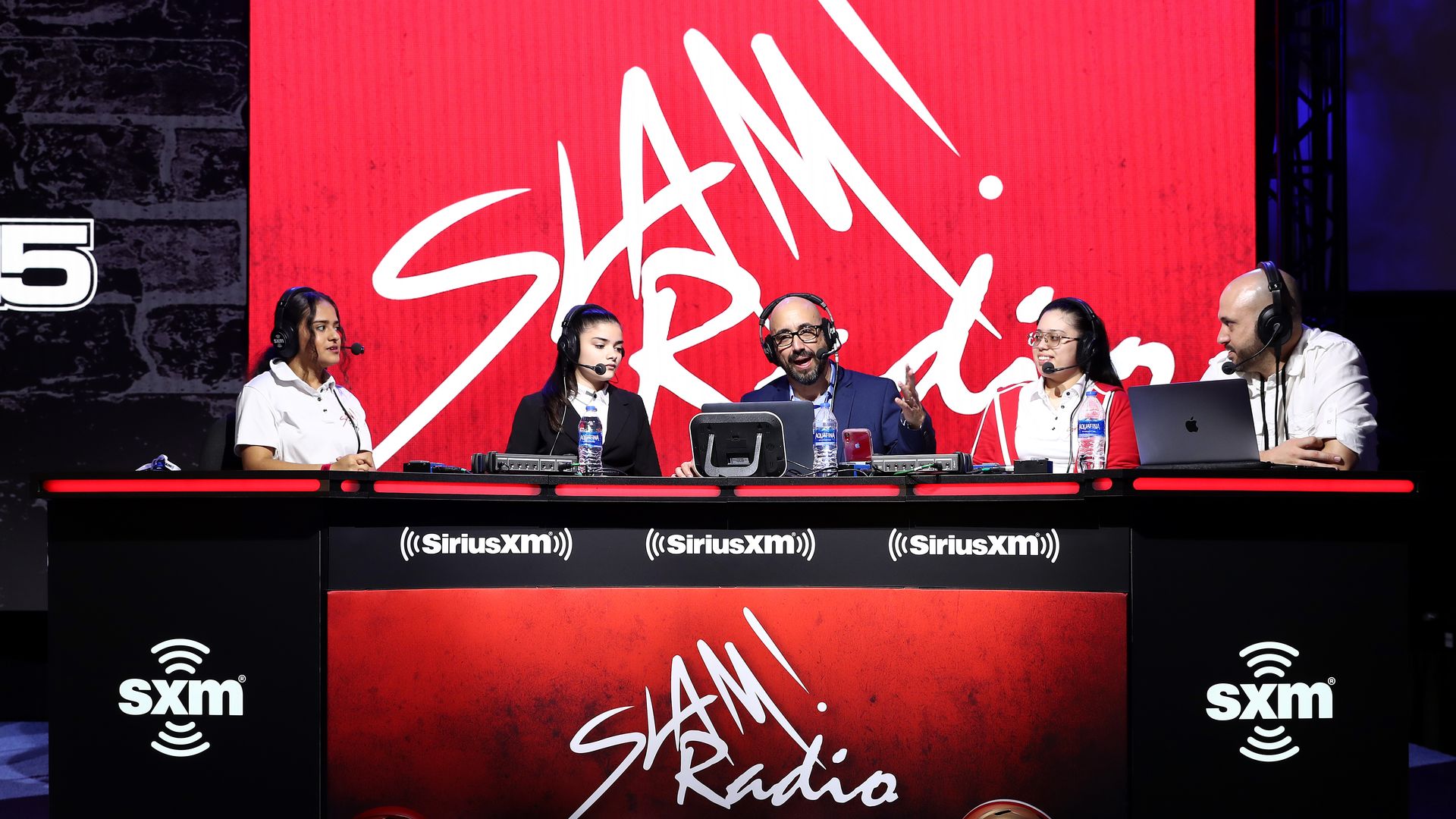 Slam Radio hosts speak onstage during day 2 of SiriusXM at Super Bowl LIV 