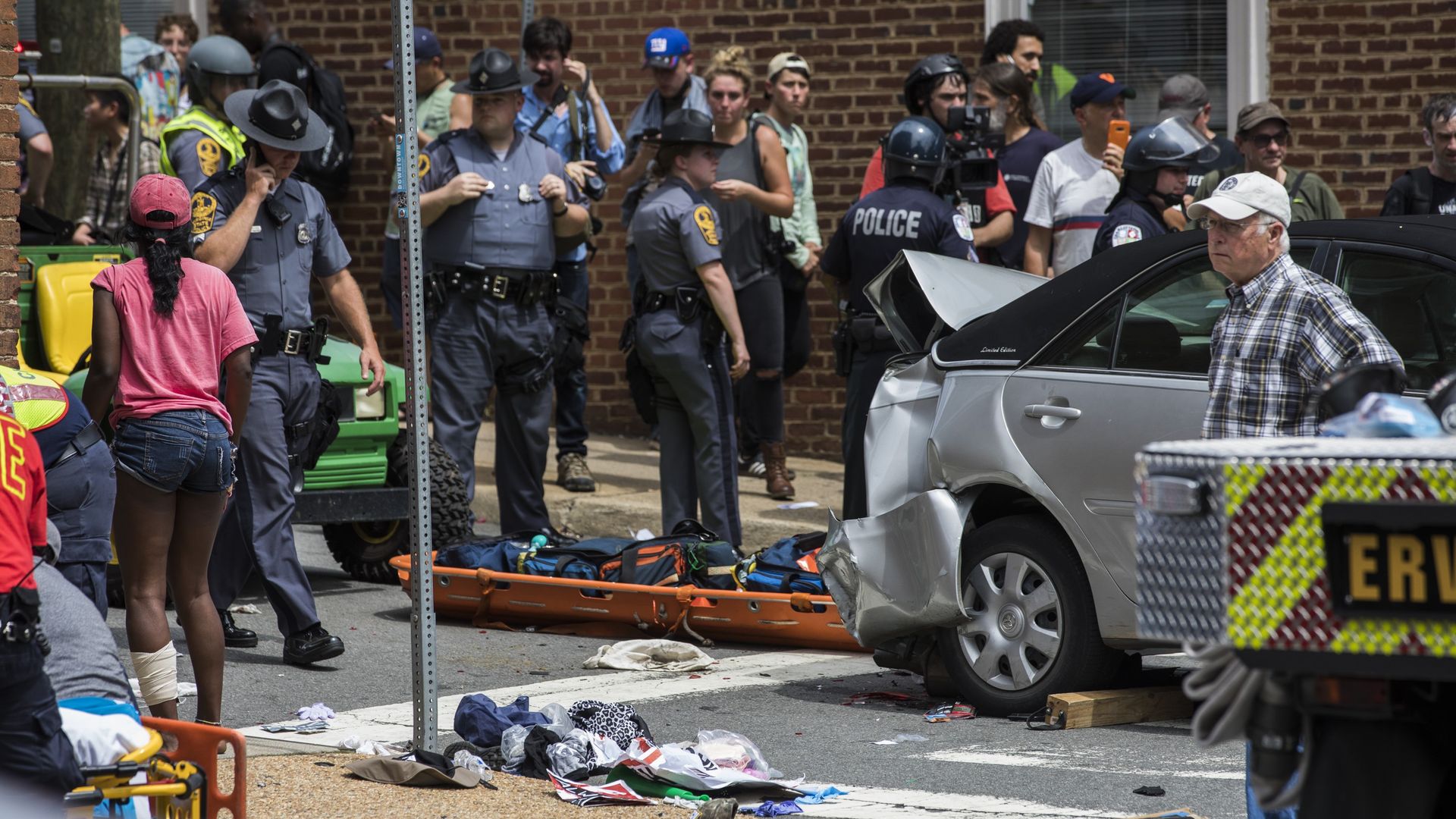 First responders and protestors attend to the injured people after a car rammed into a crowd of anti-White Supremacy protestors in Charlottesville in August  2017. 