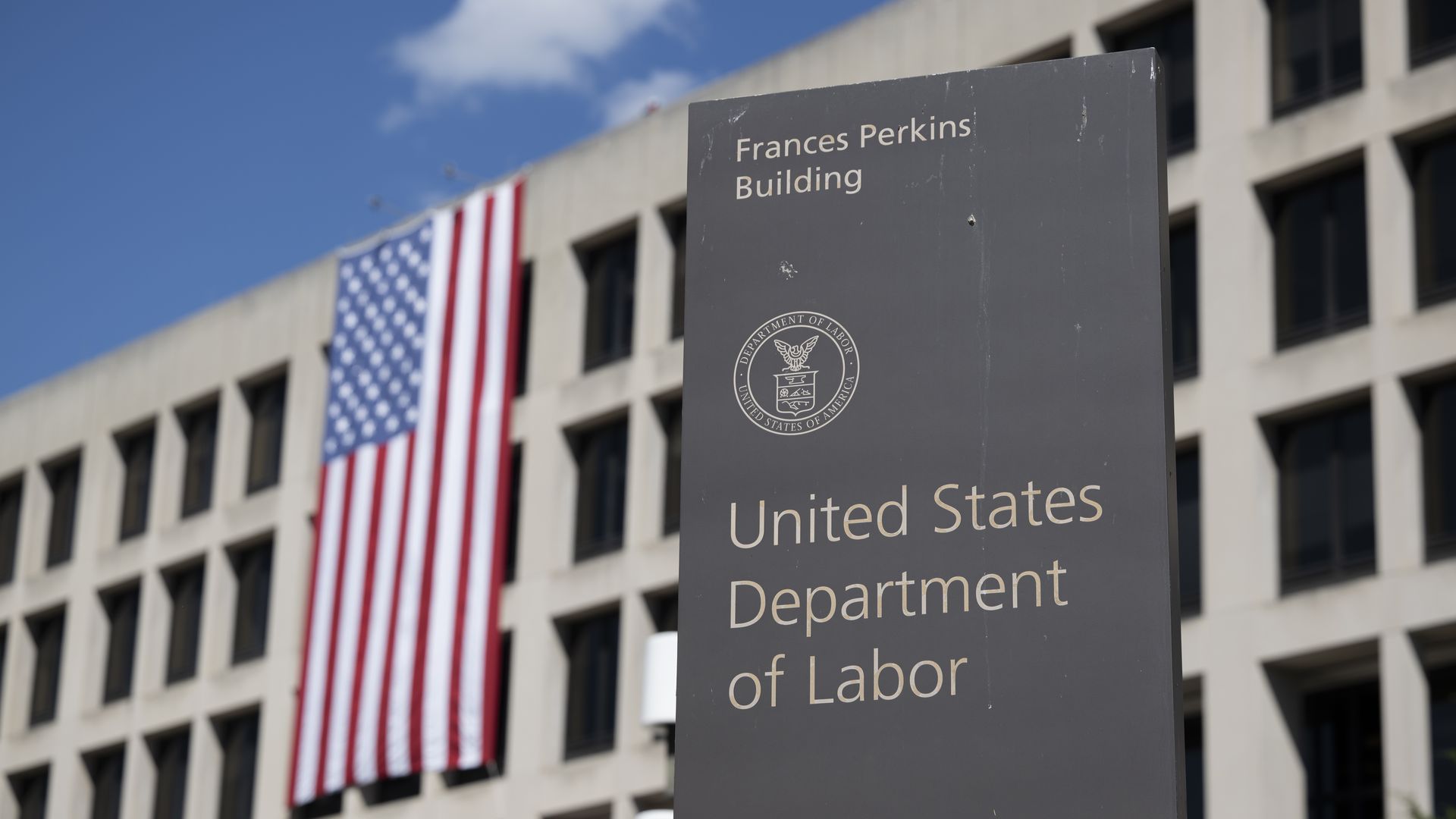 A large US flag is seen on the facade of the Department of Labor headquarters building in Washington DC
