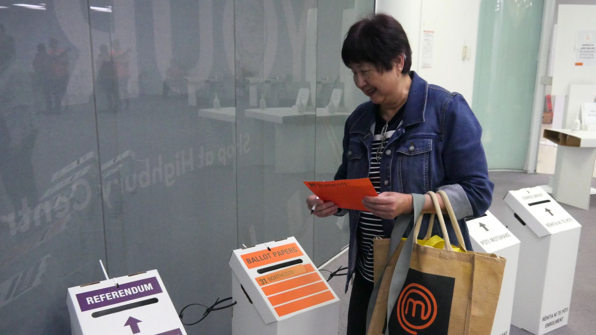 A voter casts her referendum and election ballots in Auckland, New Zealand.