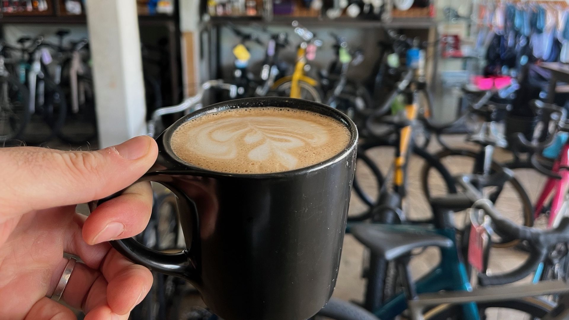 A cup of coffee at a bike shop.