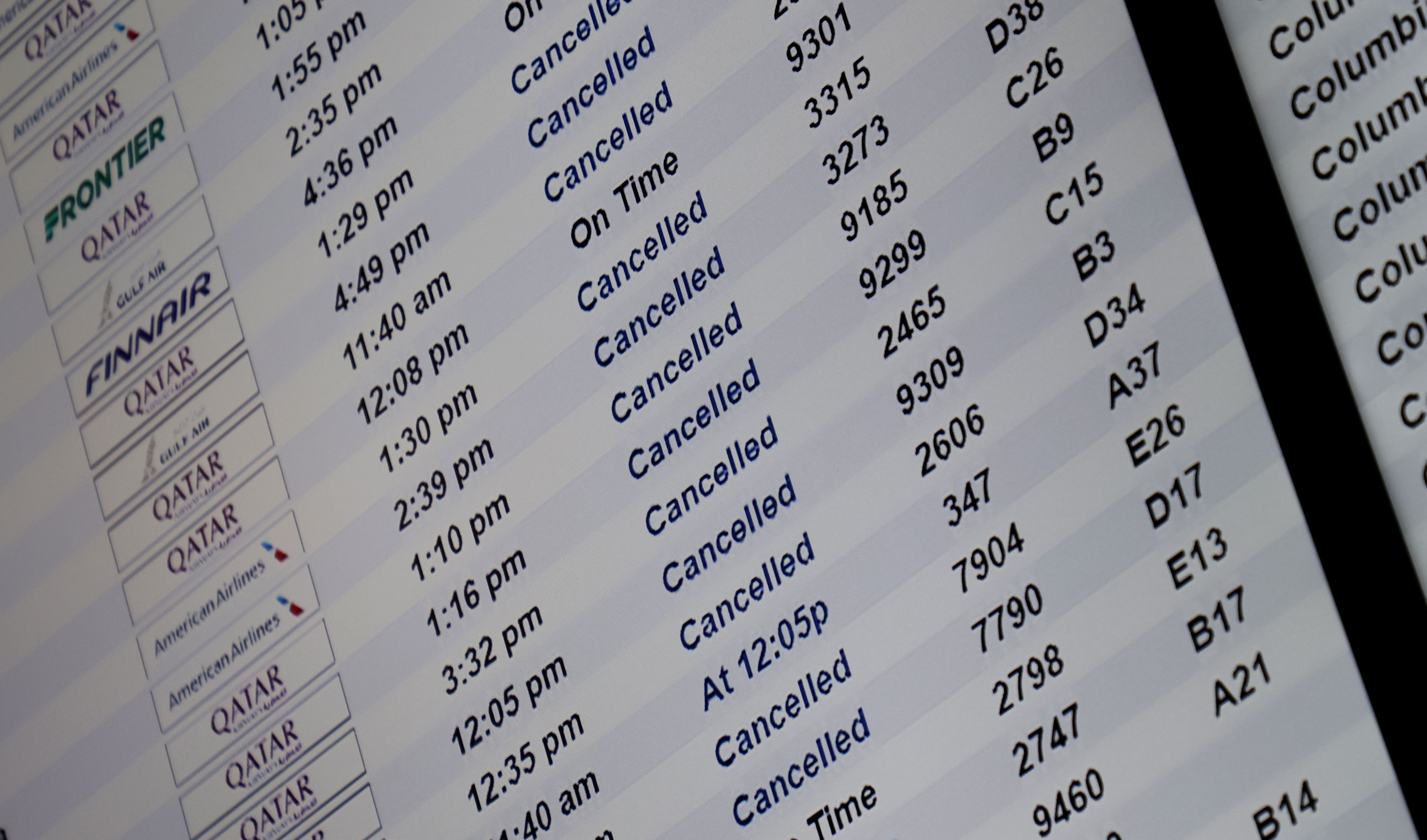 A flight board at Dallas Fort Worth International Airport shows many cancelled flights.