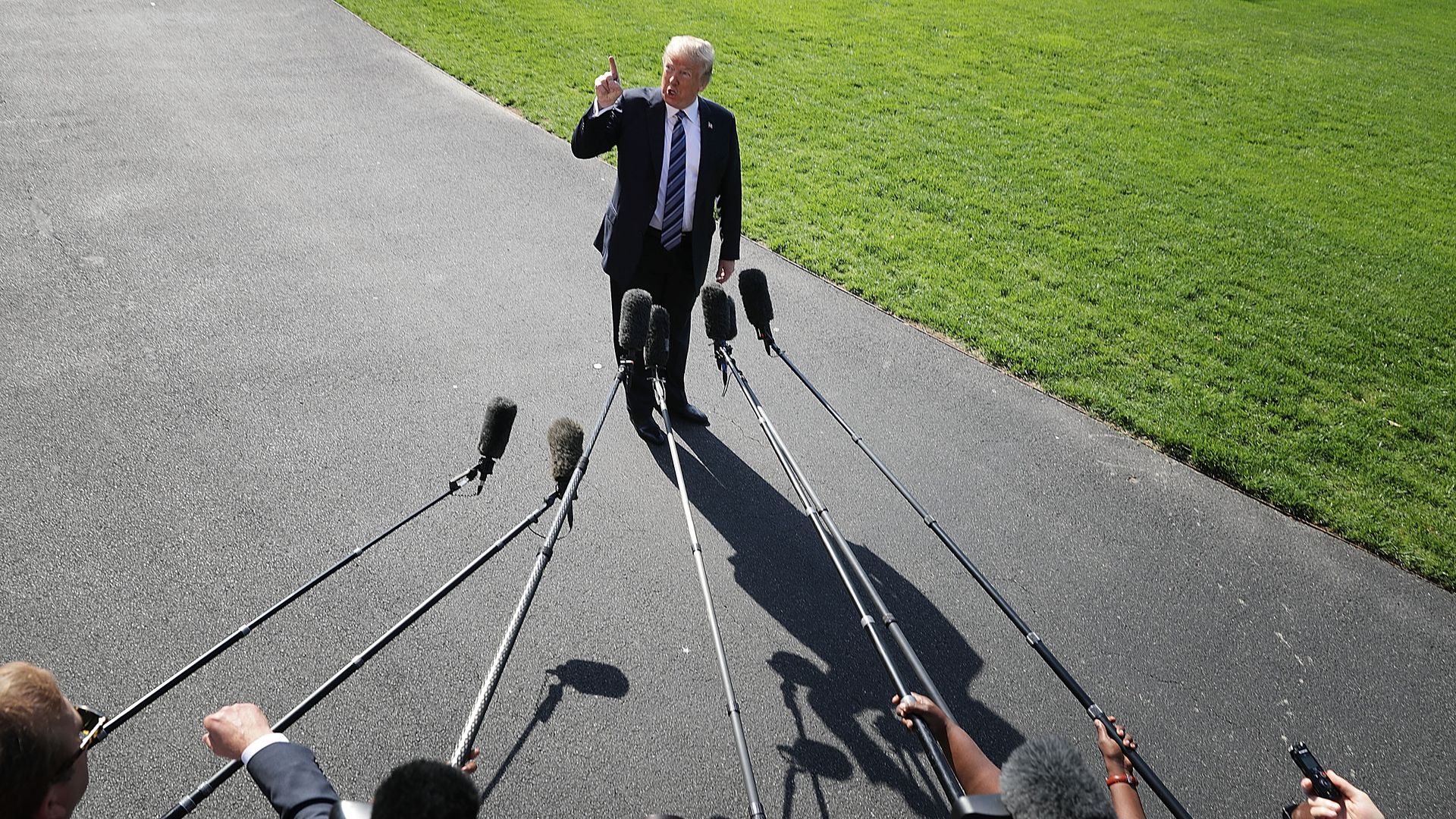 President Trump with his finger in the air talking to reporters