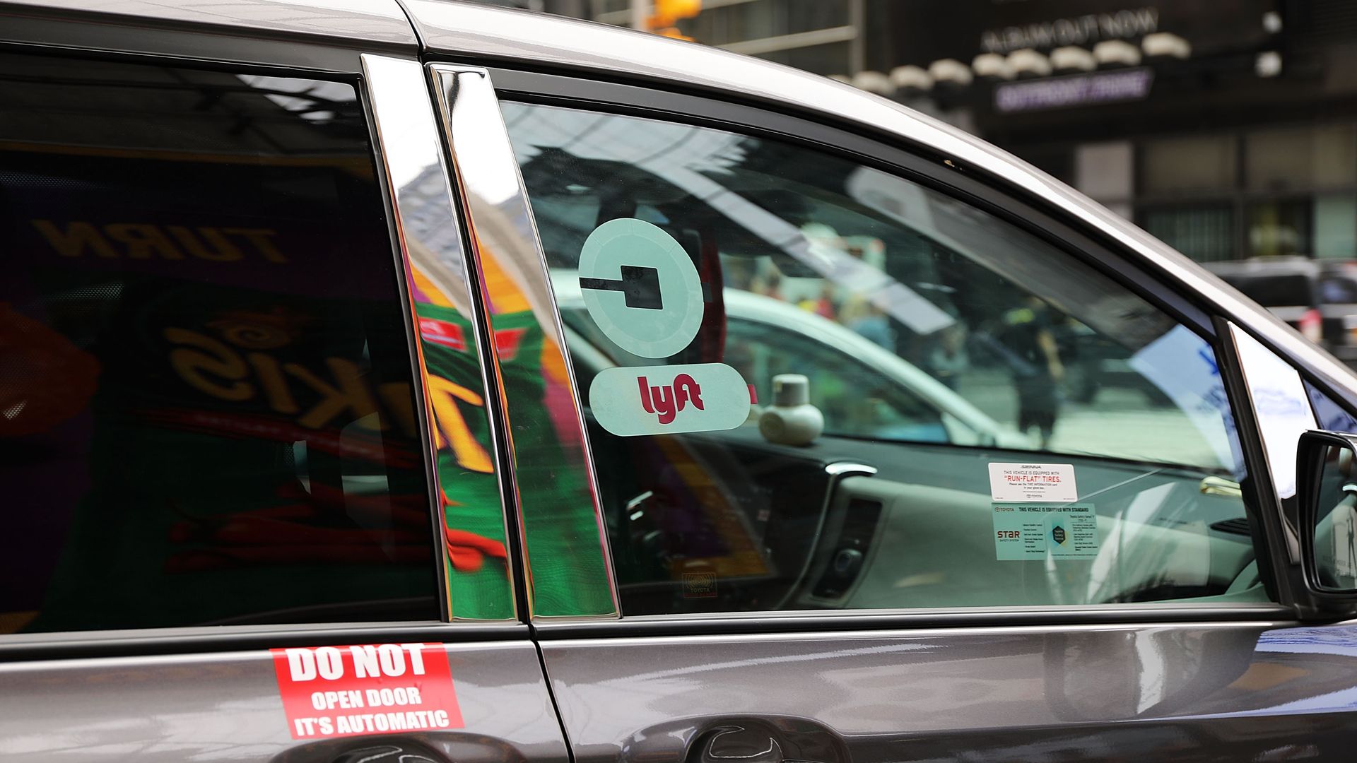 Uber and lyft stickers on a ride-hailing car