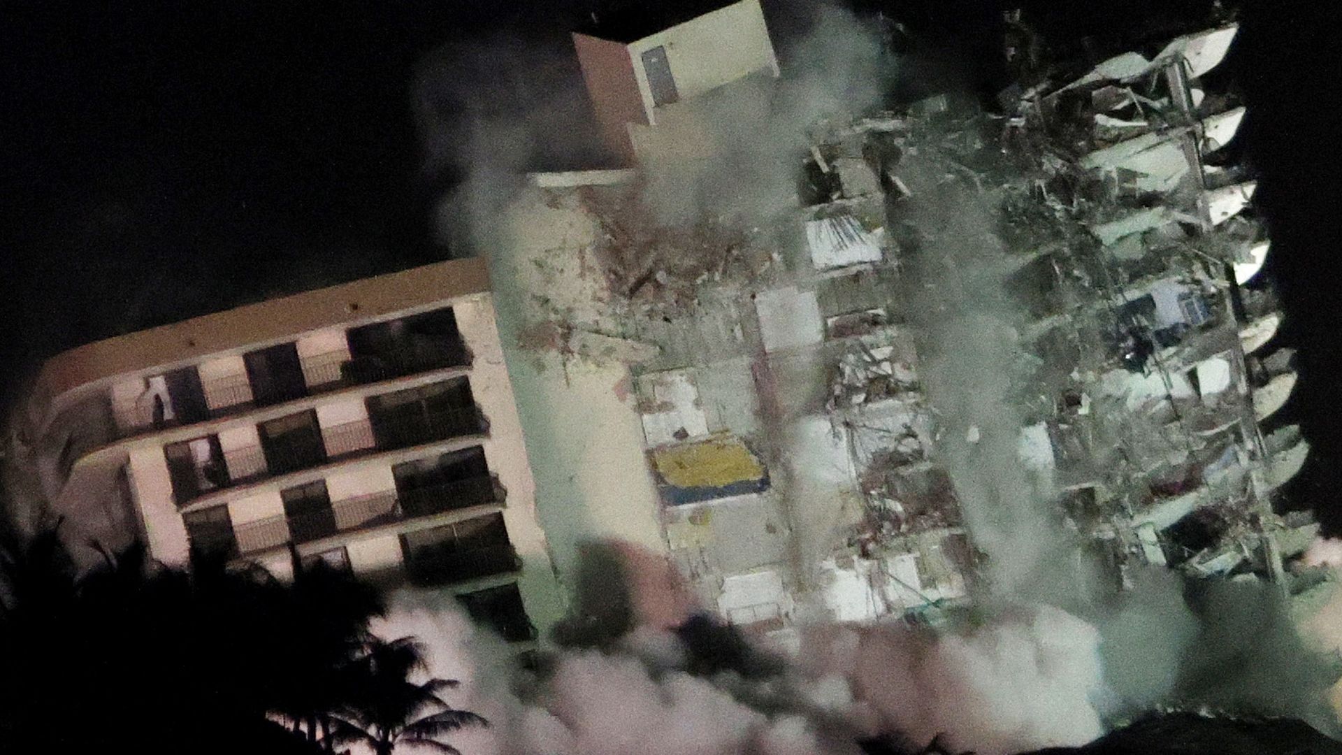 The remaining part of the partially collapsed 12-story Champlain Towers South condo building falls with a controlled demolition on July 4, 2021 in Surfside, Florida.