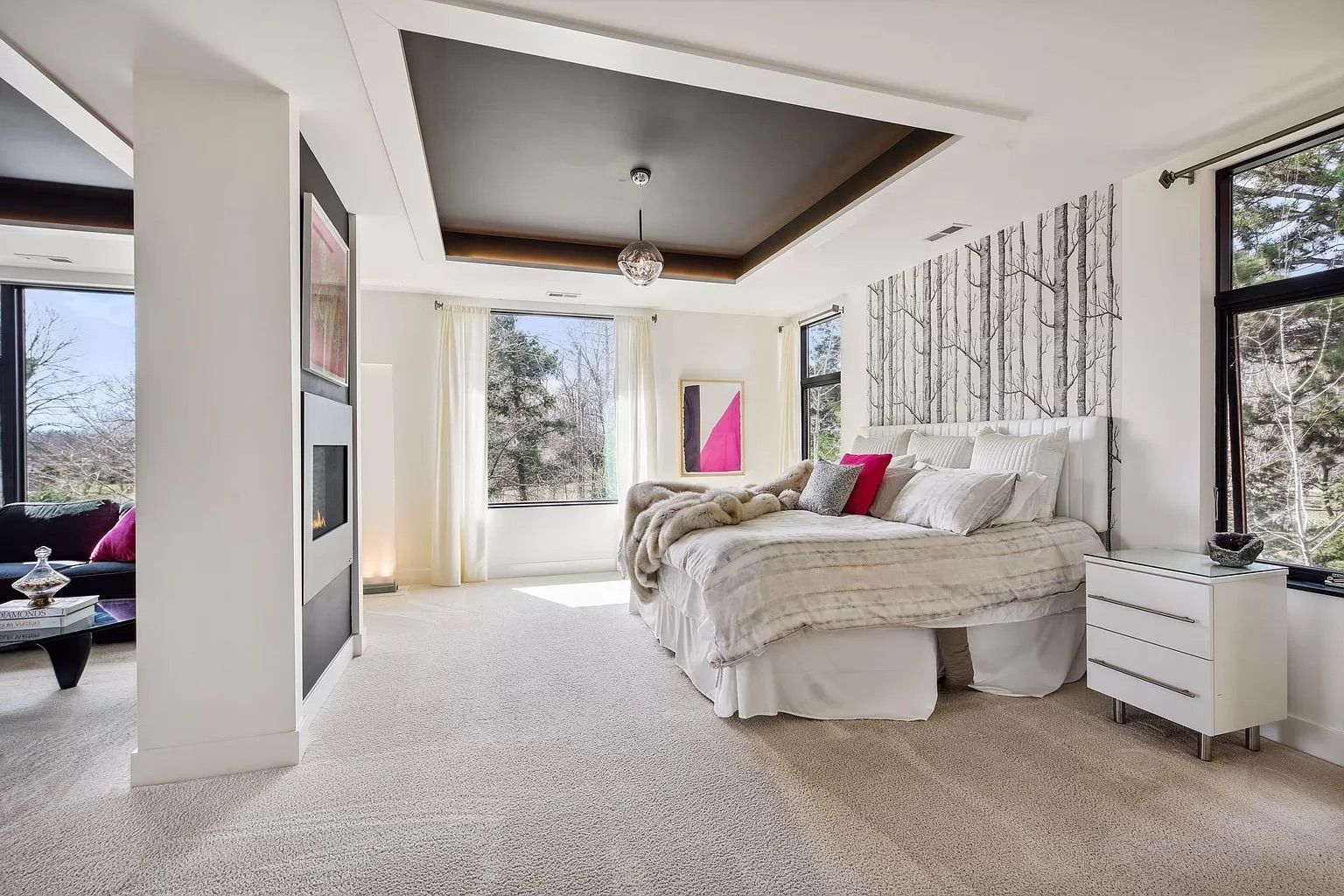 A bedroom with white walls and white furniture.