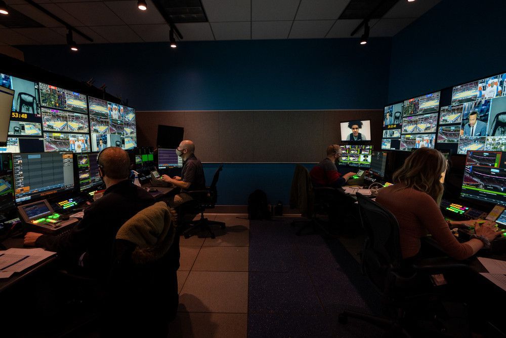 Picture of a control room, several screens are on each side
