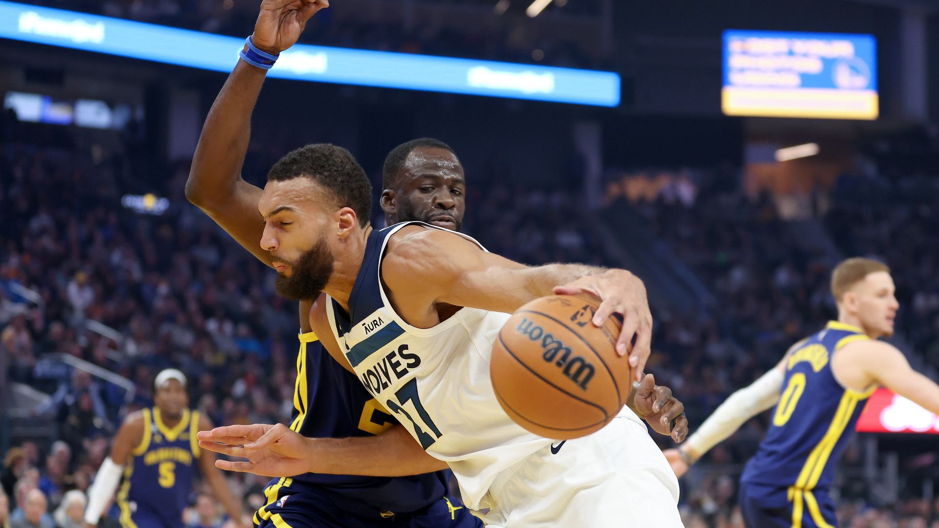 Rudy Gobert dribbles against Draymond Green 