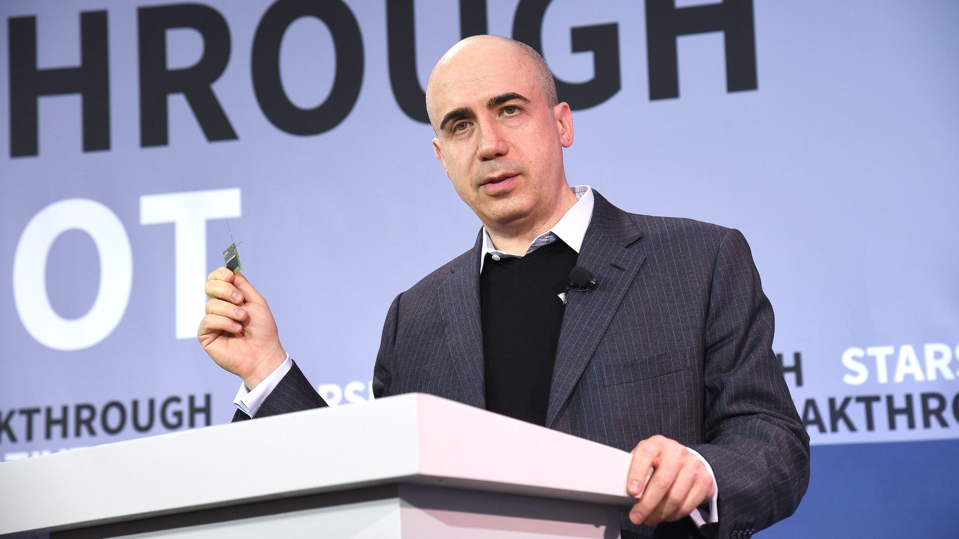 Yuri Milner demonstrates a new chip on stage at a One World Observatory event on April 12, 2016 in New York City.