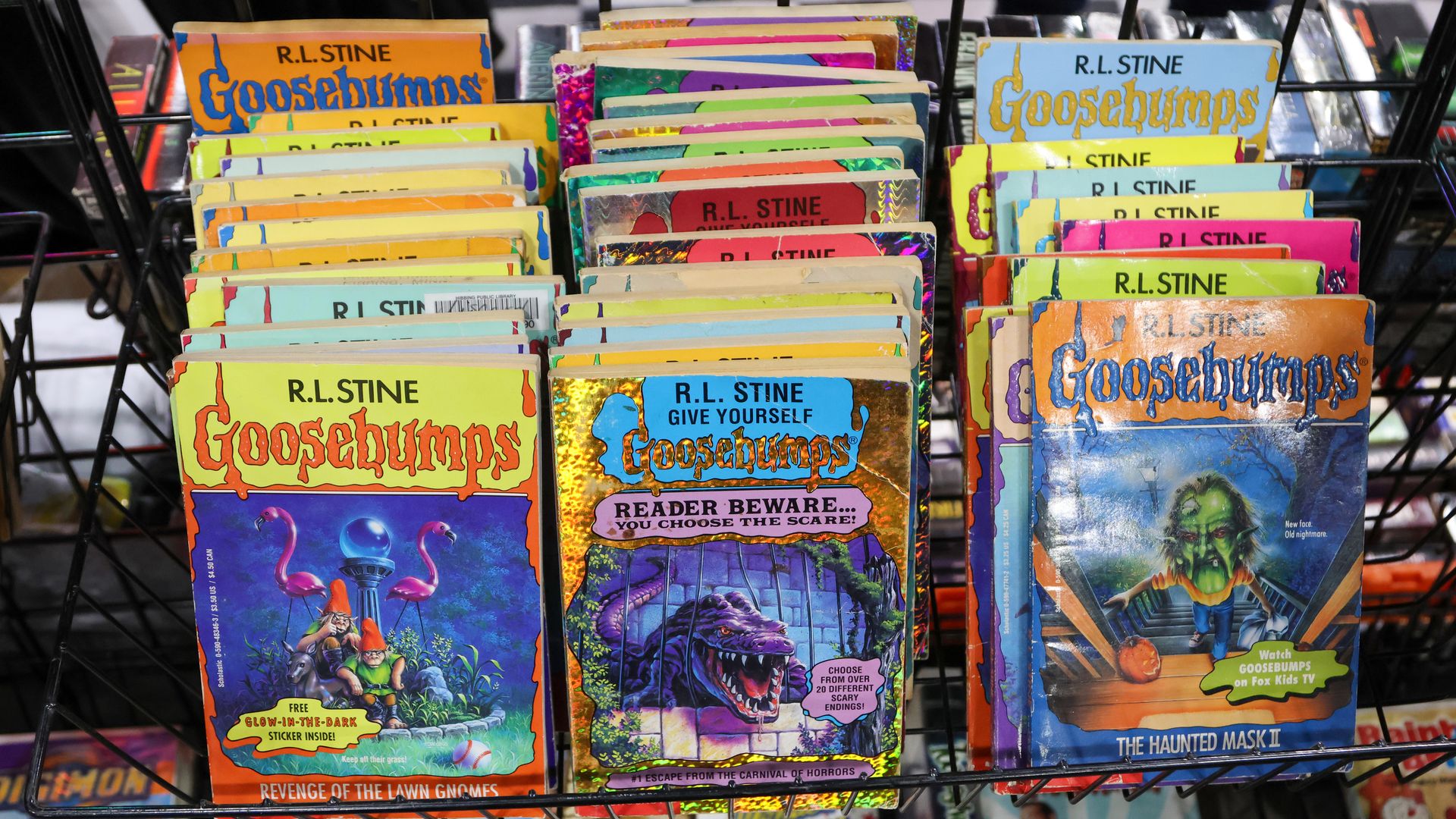 Rows of "Goosebumps" paperback books by R.L. Stine on a shelf.