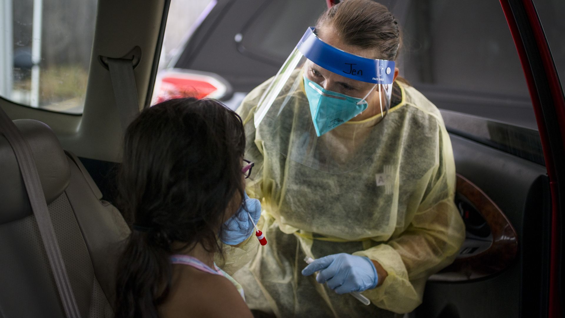 A health care worker testing a child for coronavirus in Austin, Texas, in August.