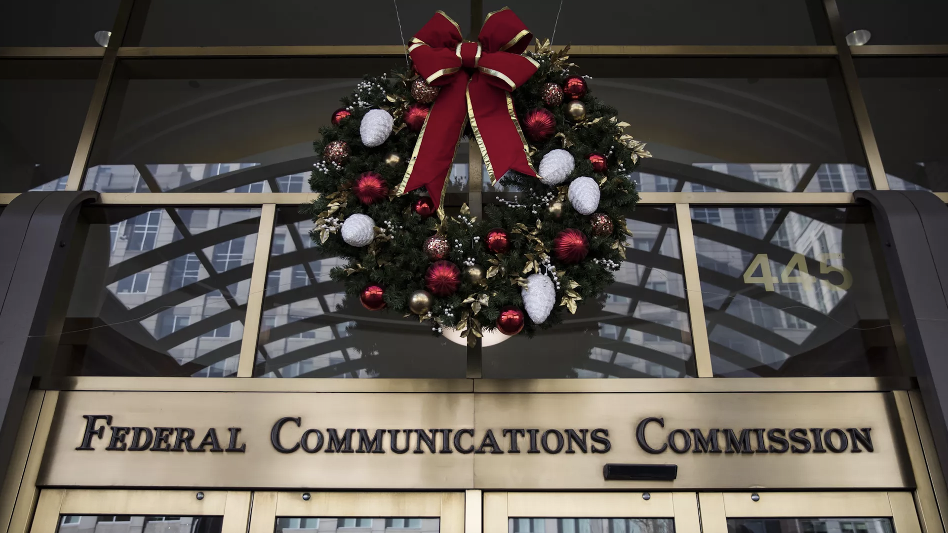 An image of the FCC building with a Christmas wreath above the agency's name.