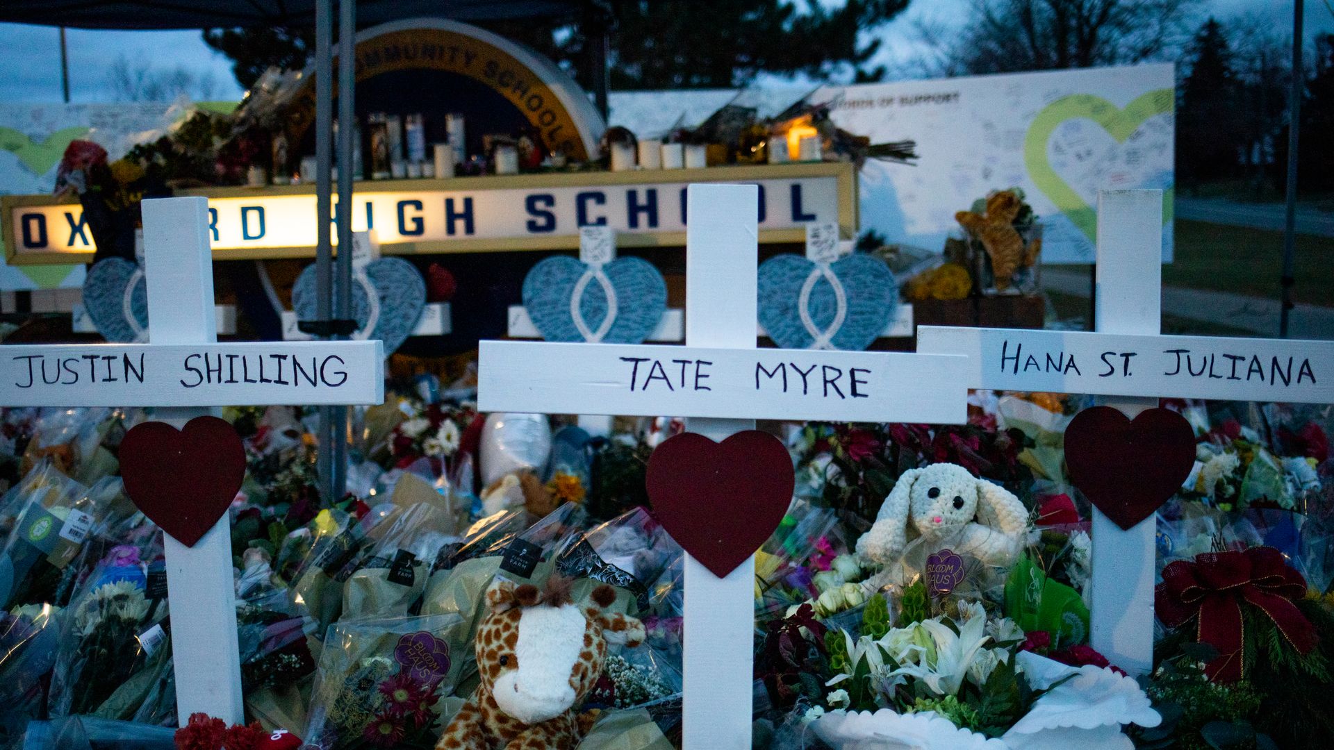Photo of a memorial in front of the Oxford High School sign