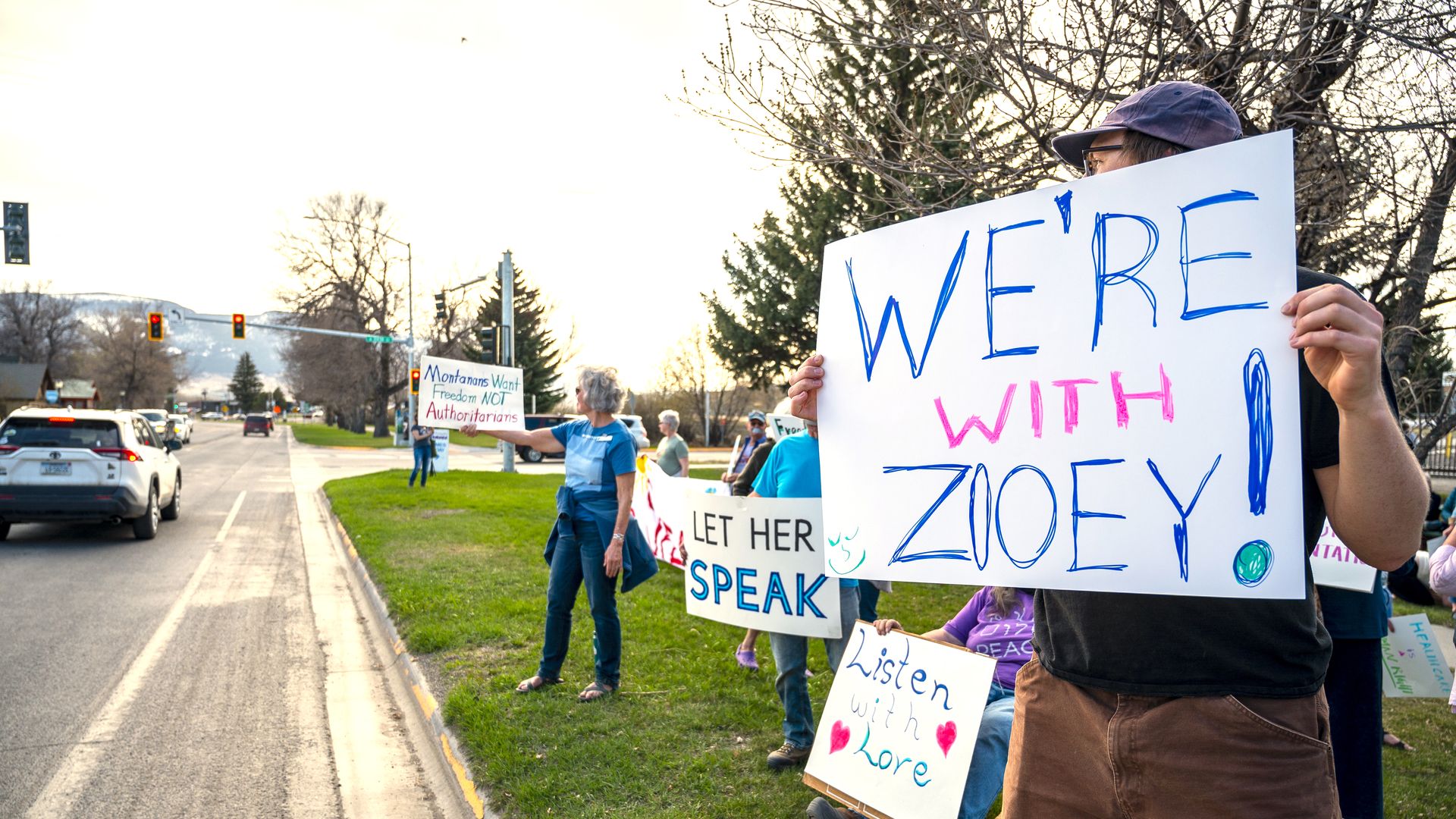Supporters hold signs near a rally in support of transgender lawmaker Zooey Zephyr