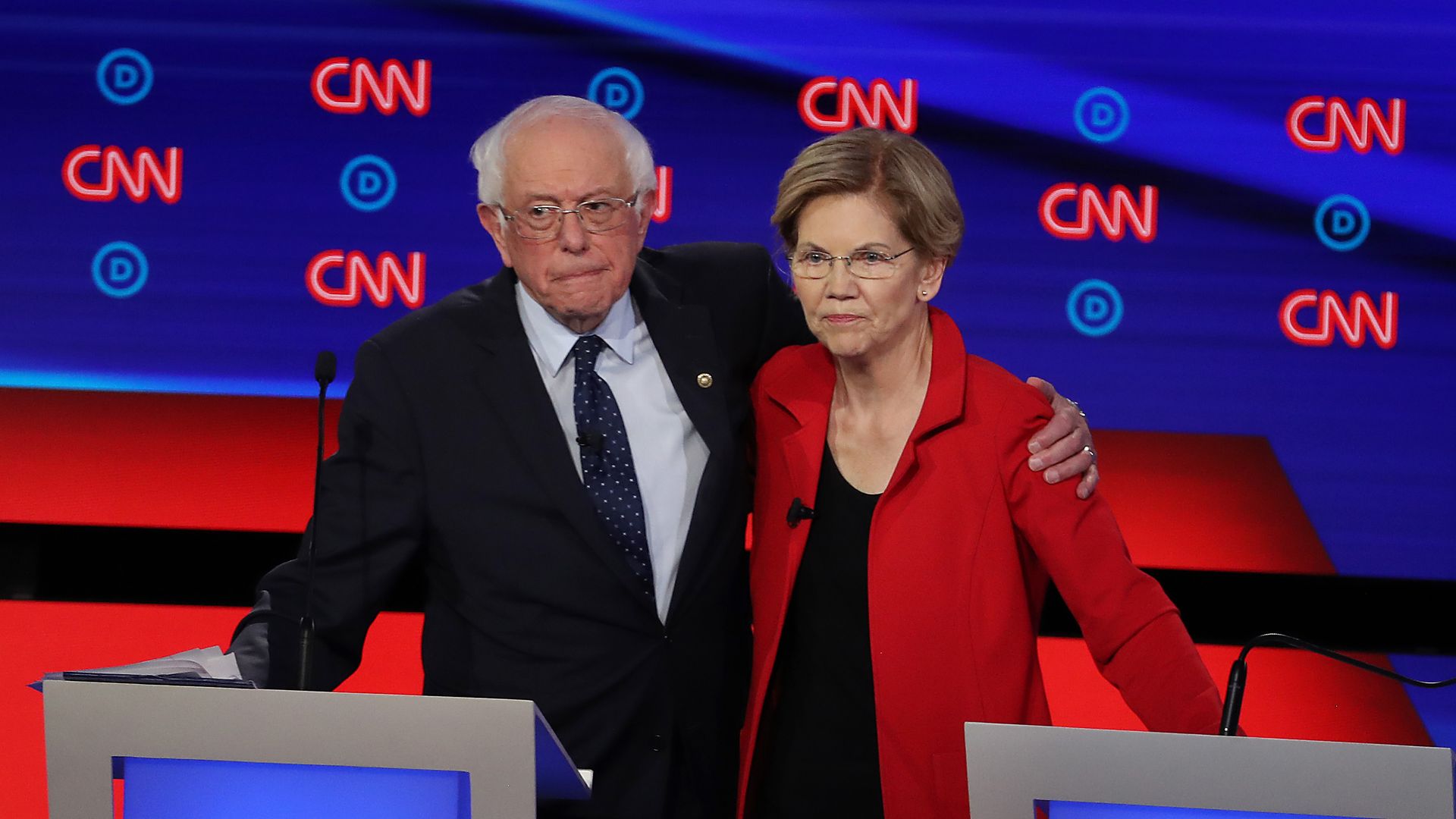 Democratic presidential candidate Sen. Bernie Sanders (I-VT) (L) and Sen. Elizabeth Warren (D-MA) embrace 