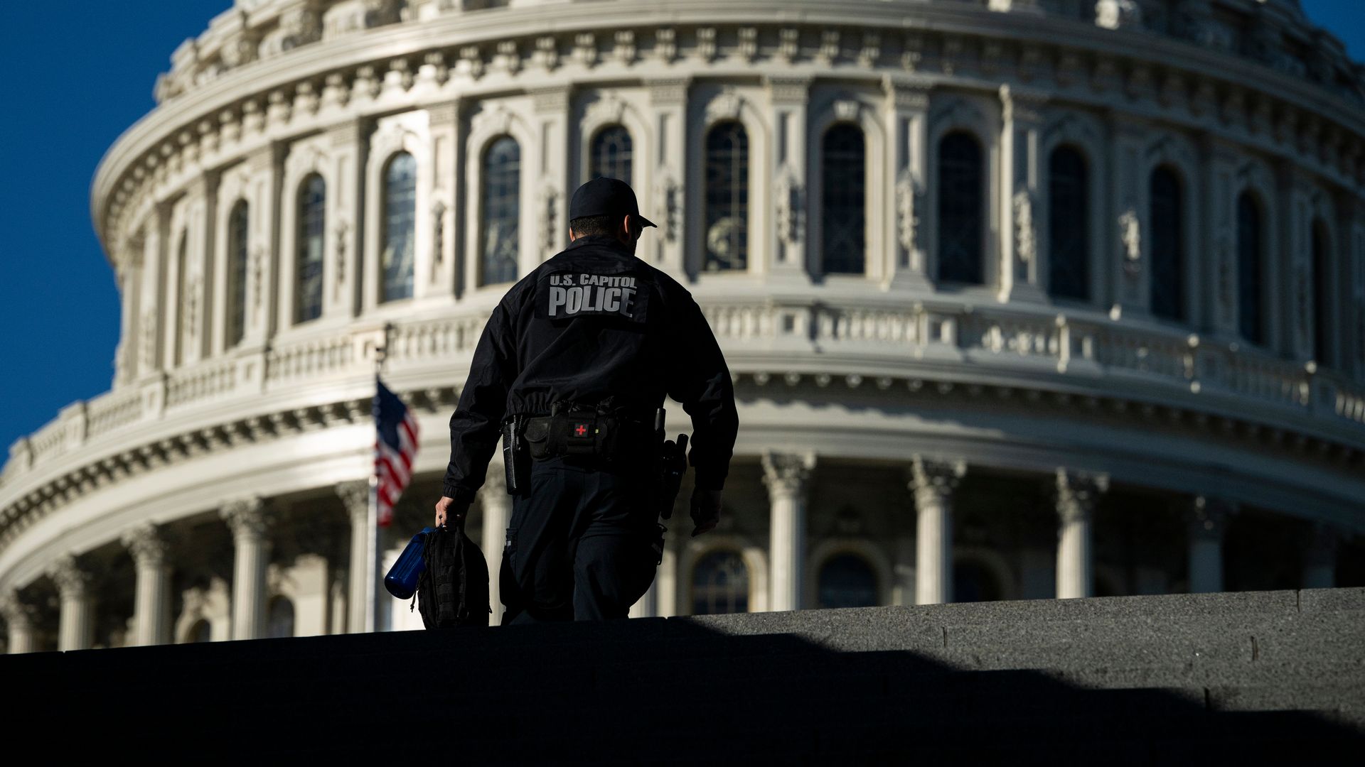 Capitol Police officer against the backdrop of the Capitol dome.