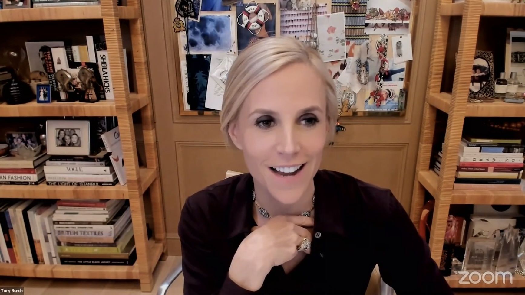 Tory Burch over Zoom in front of bookshelves