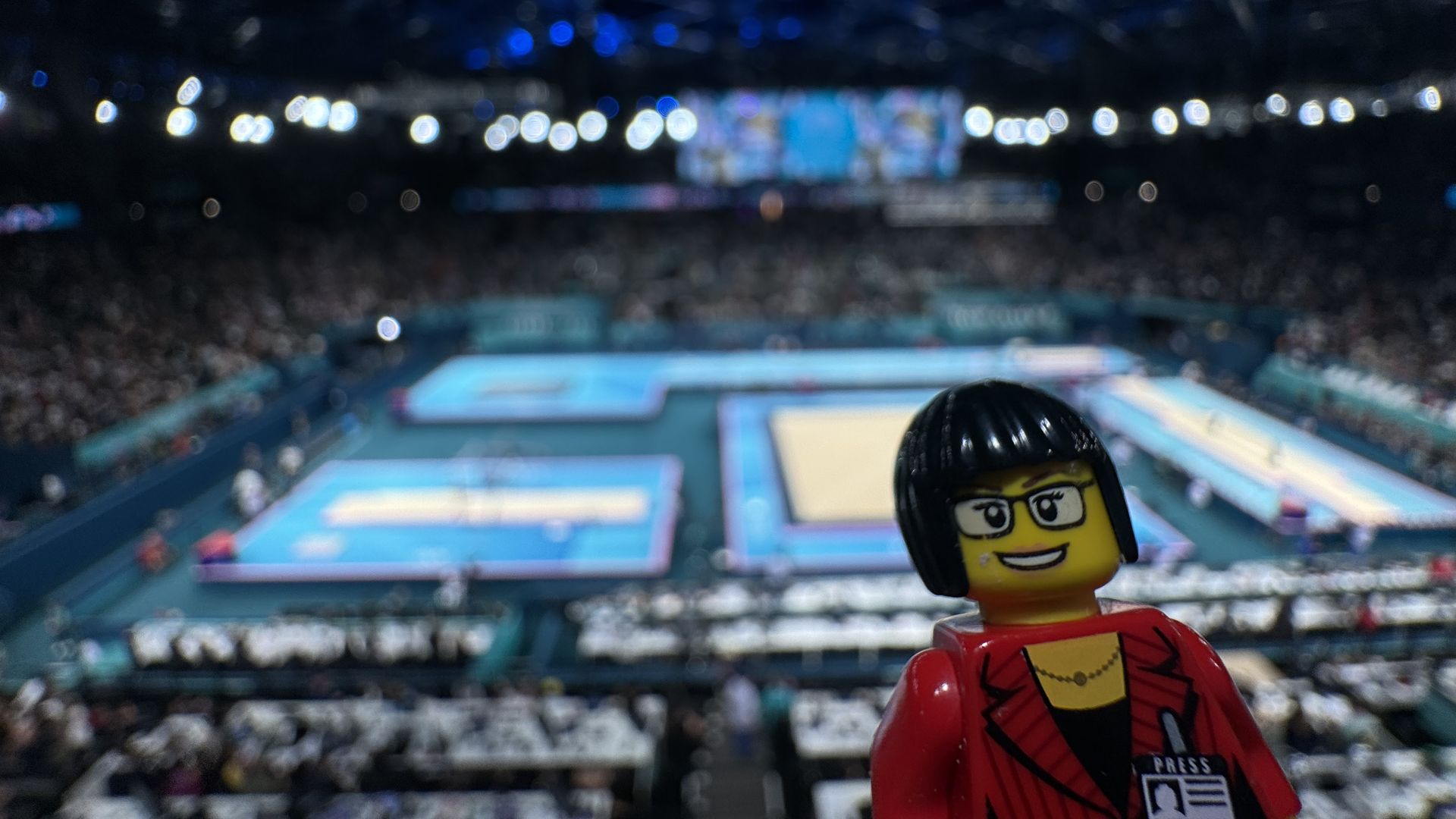 A Lego version of Axios' Ina Fried with the Paris Olympics gymnastics venue in the background