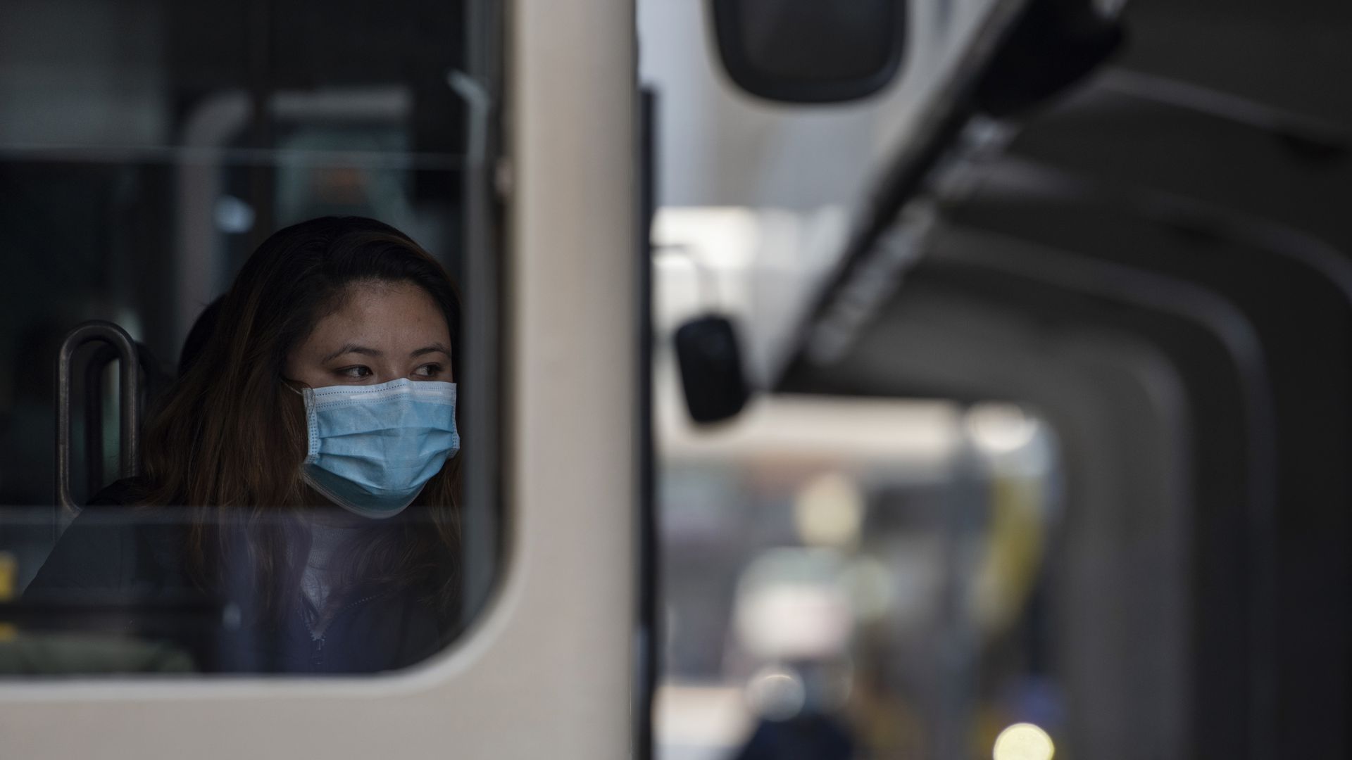 A Hong Kong commuter wears a face mask