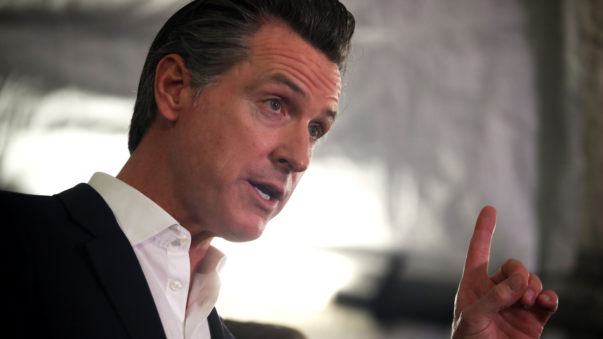 Photo of Gavin Newsom speaking while gesturing with one hand