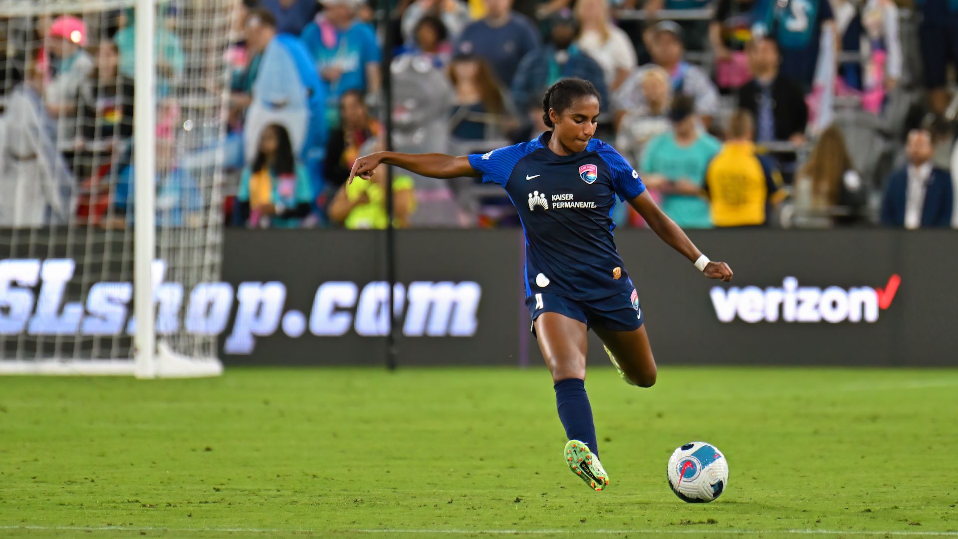 San Diego Wave defender Naomi Girma prepares to kick a ball on the field. 