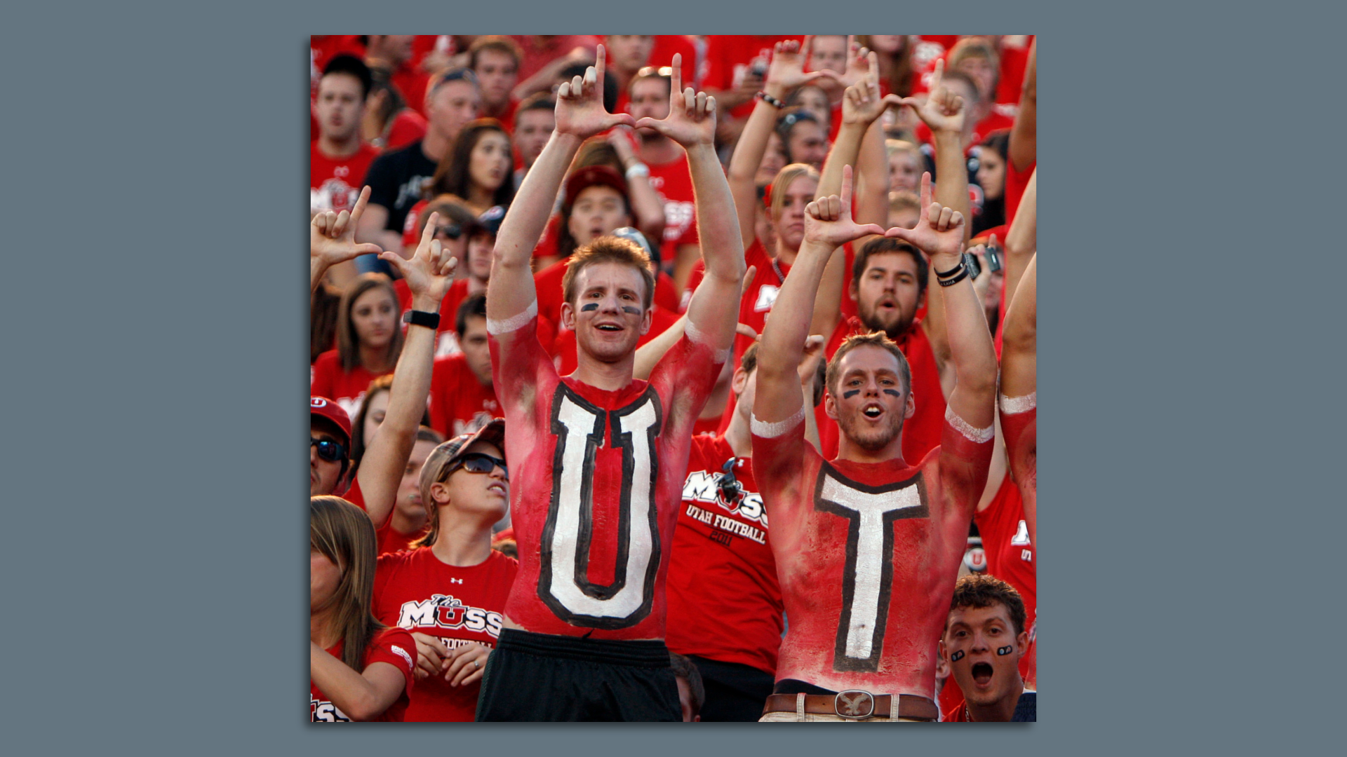 University of Utah fans are topless and have the letters U & T painted on their chests.