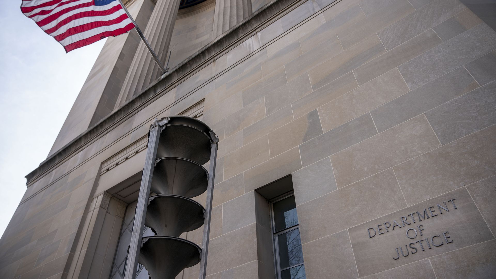 The American flag flies outside the U.S. Department of Justice (DOJ) headquarters in Washington, D.C., U.S, on Wednesday, Feb. 19, 2020. 