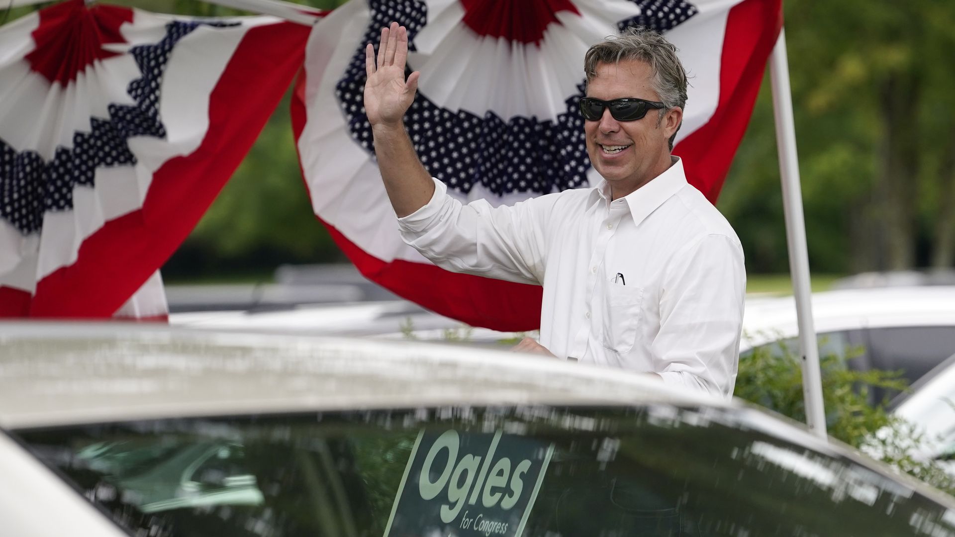 Andy Ogles waves to voters on Election Day.