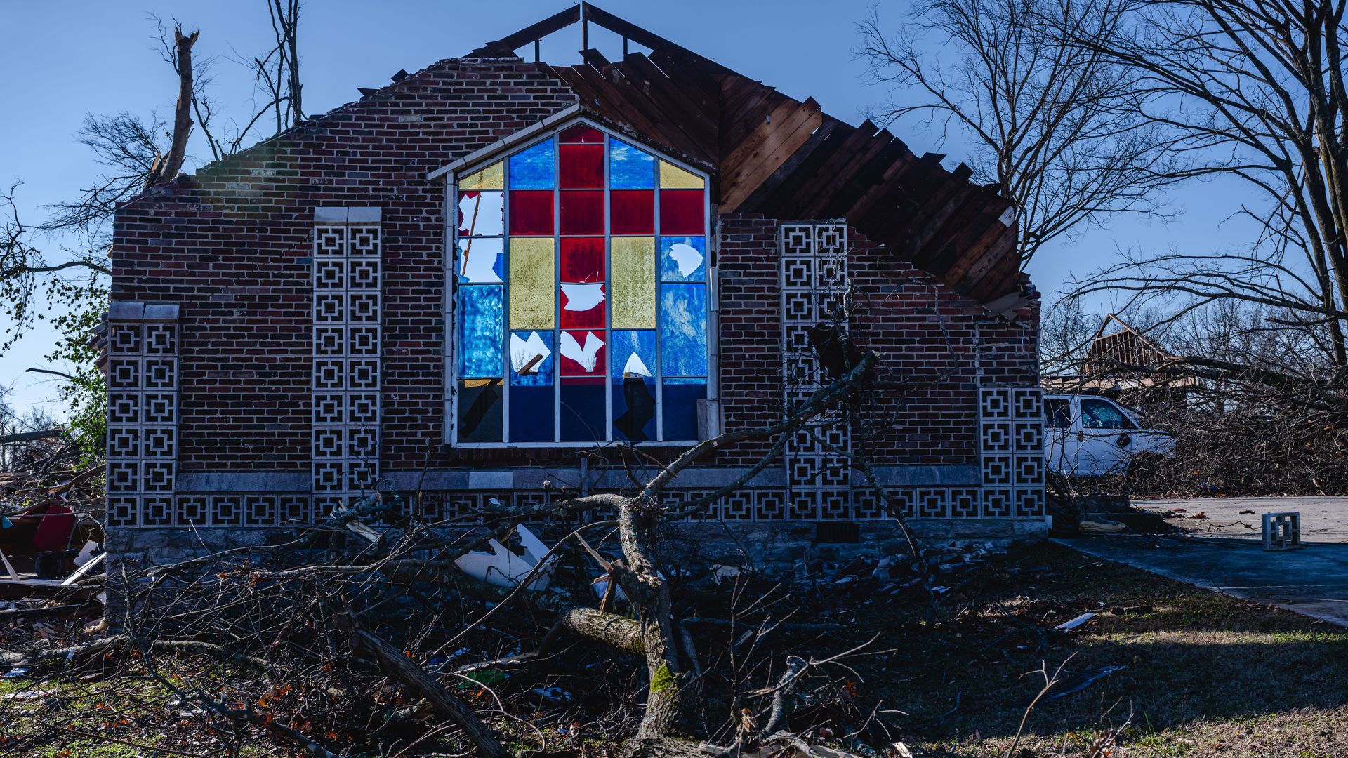 Debris surrounding a lone wall left standing at a church.