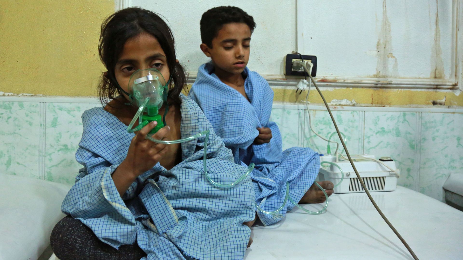 Two Syrian children apparently suffering from nerve gas attack in a clinic