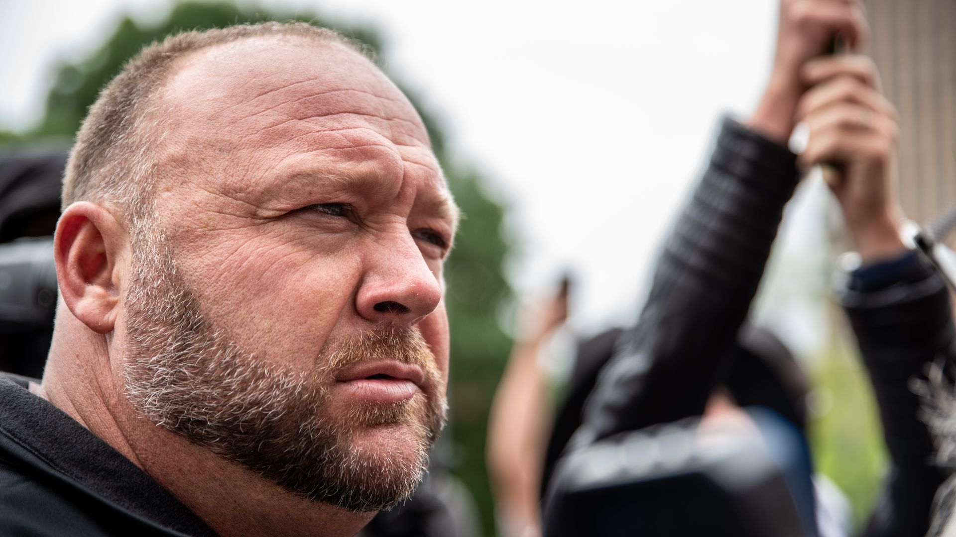  Infowars founder Alex Jones listens to a supporter at the Texas State Capital building on April 18, 2020 in Austin, Texas. 
