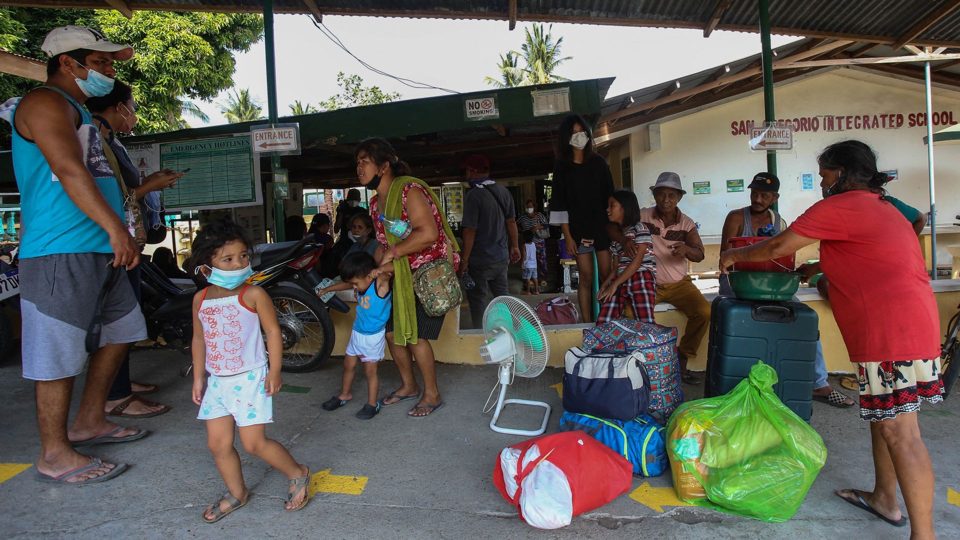 Residents living near Taal volcano evacuate to a public school in Laurel, Batangas, on March 26, 2022