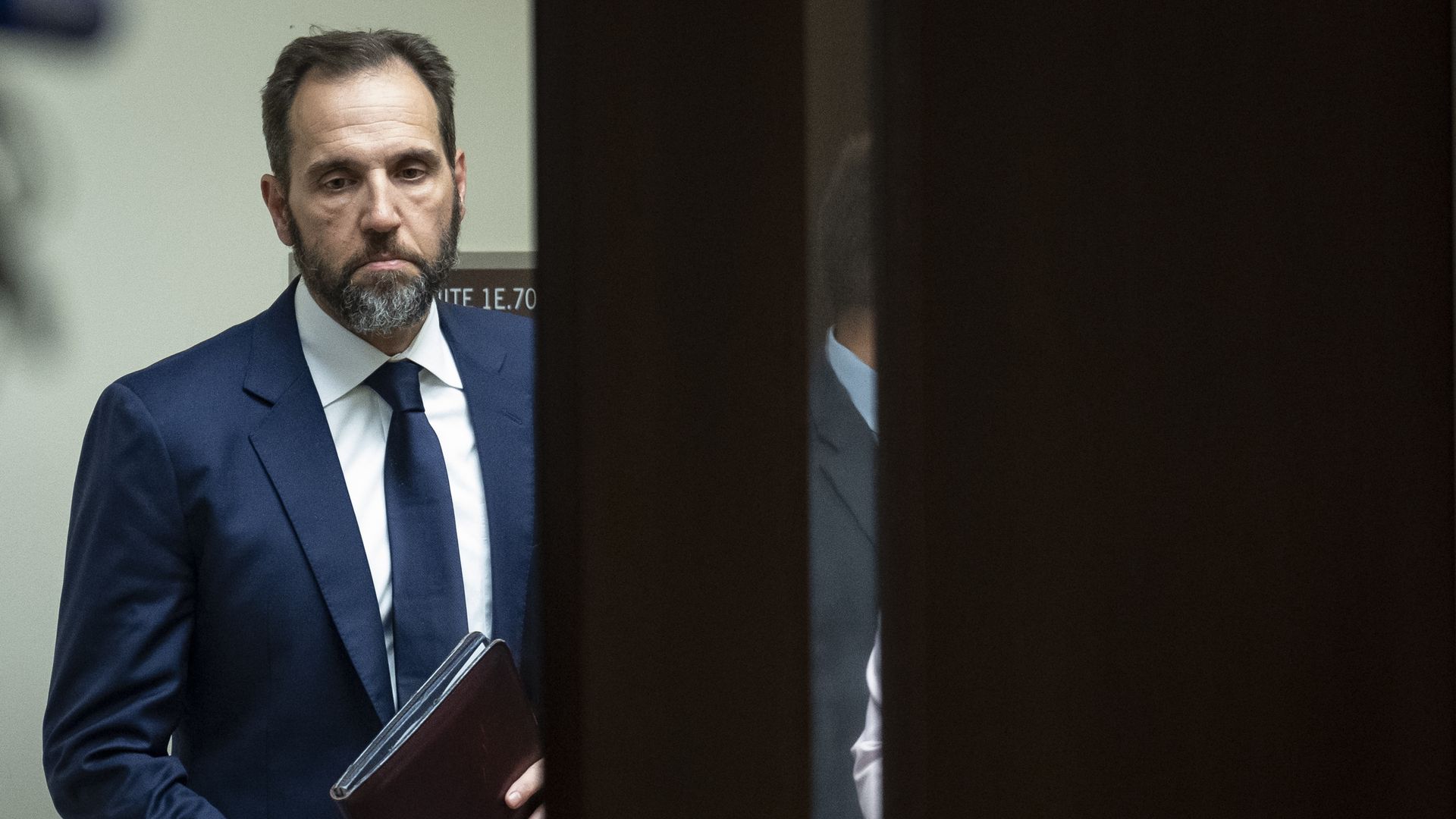 Jack Smith arrives before giving remarks, carrying a folder full of papers.