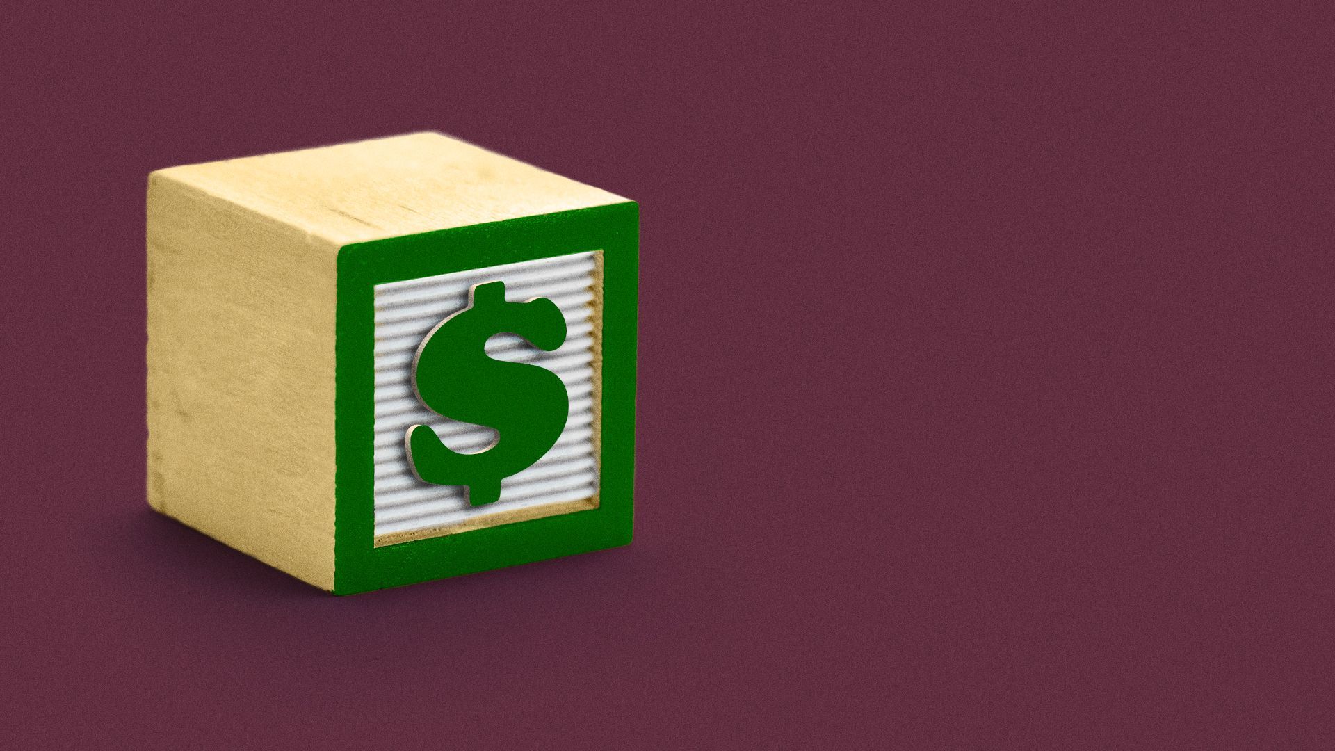 Illustration of a child's block with a dollar sign on it. 