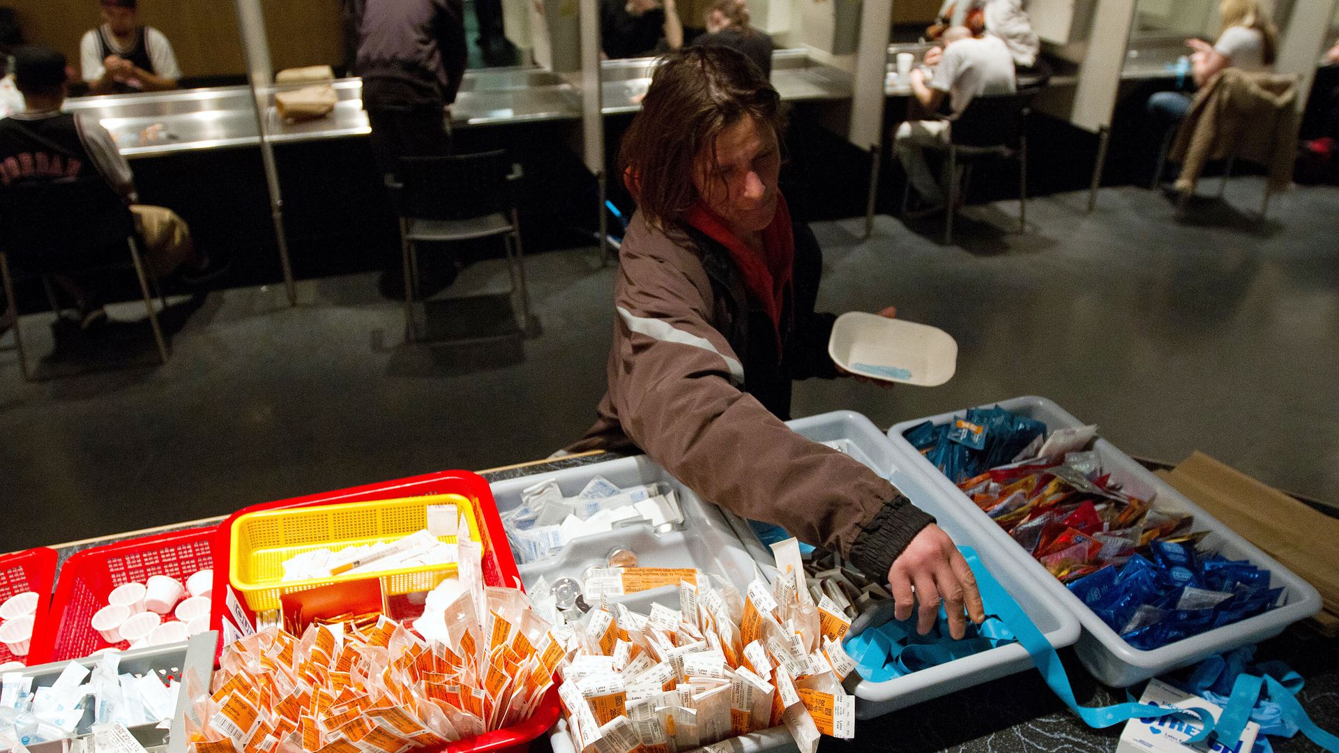 A person collecting needles and other supplies in a supervised injection center in Vancouver, Canada, in May 2011.