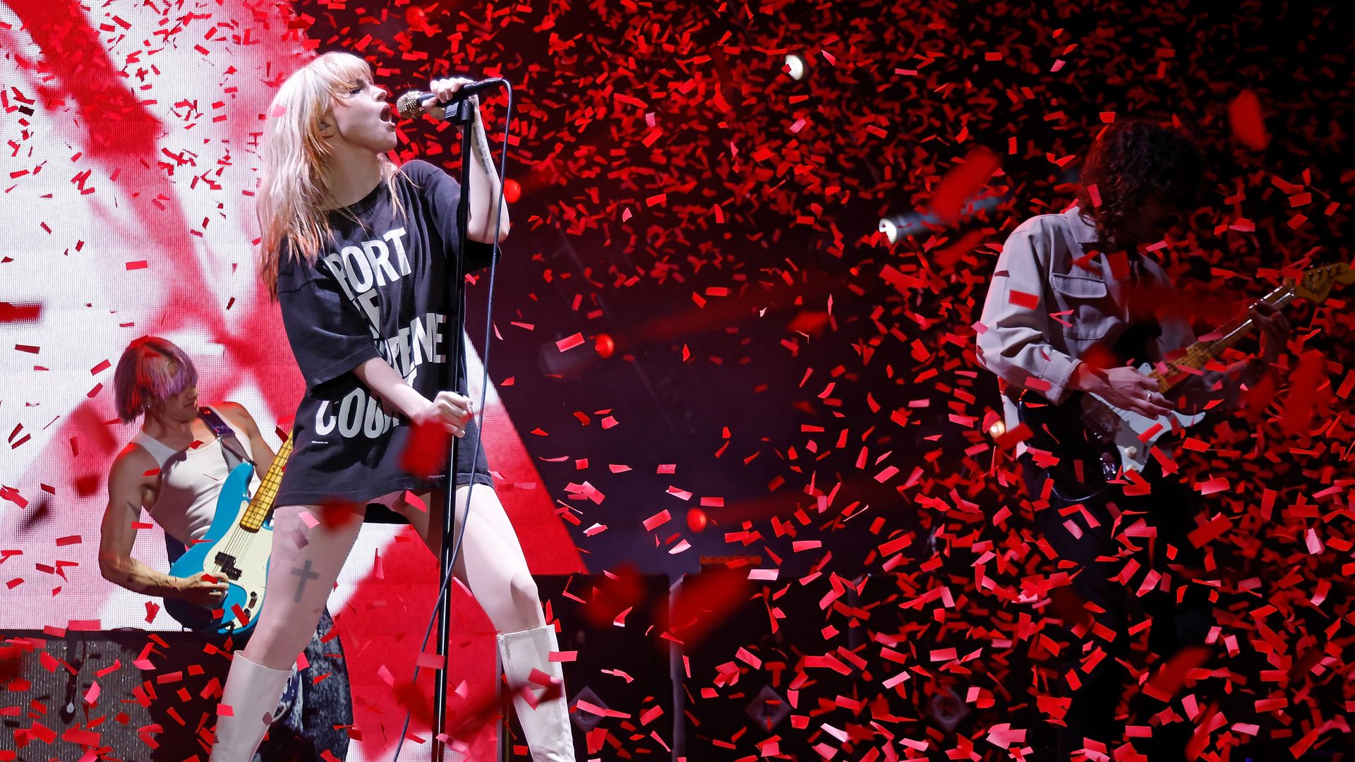 Hayley Williams of Paramore sings alongside bandmates as red confetti falls