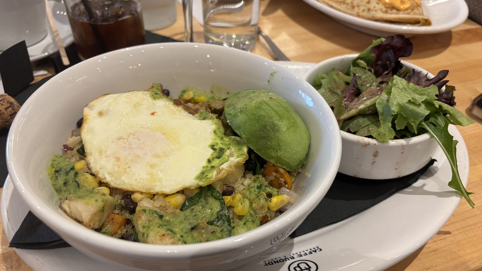 A bowl of food with an egg on top