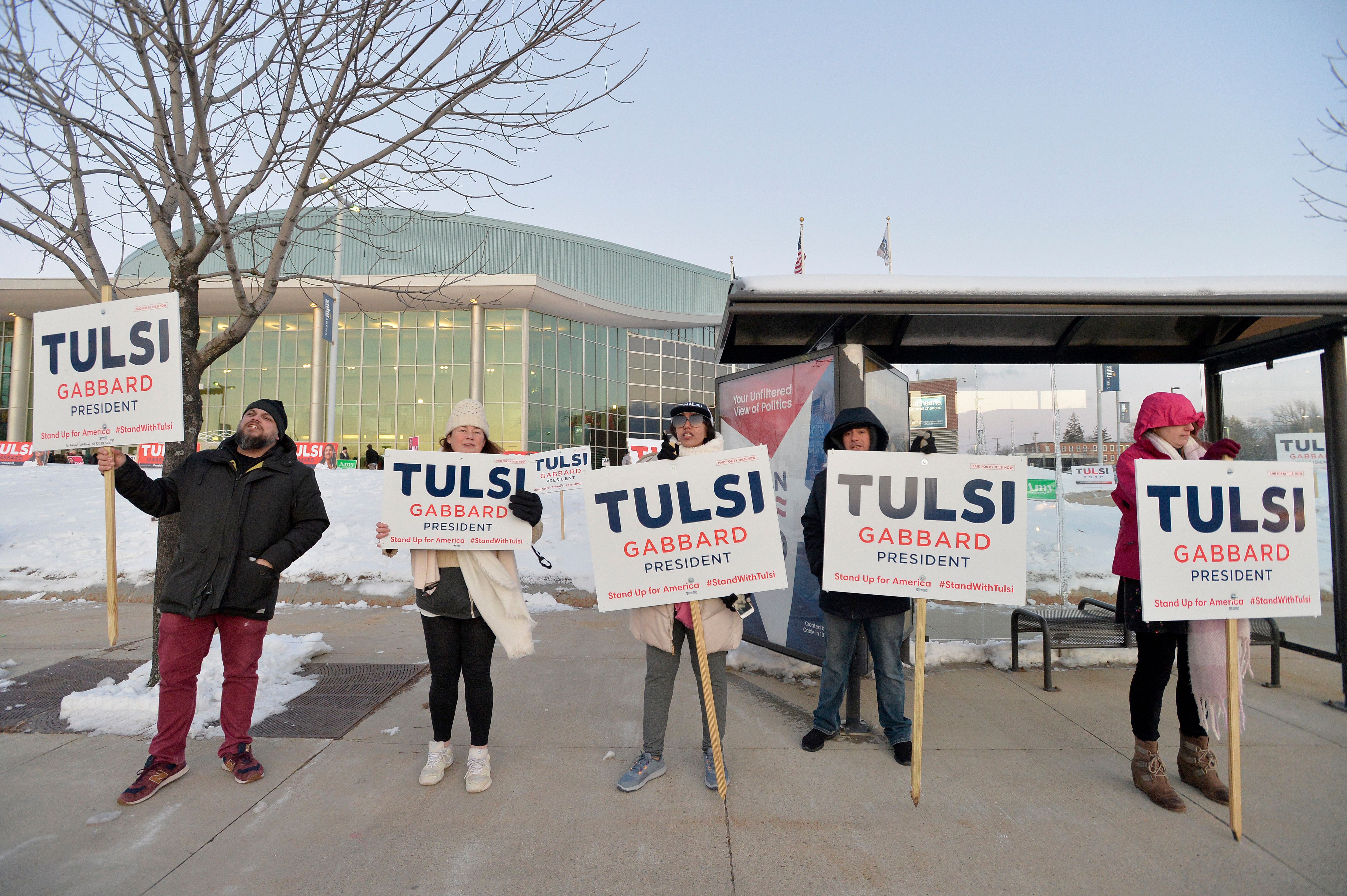 Supporters of Democratic presidential hopeful Representative for Hawaii Tulsi Gabbard rally outside SNHU arena in Manchester, New Hampshire, on February 8